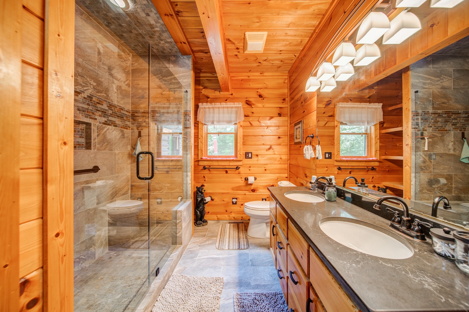 The upper-level king en suite offers a double vanity & spa-like glass shower