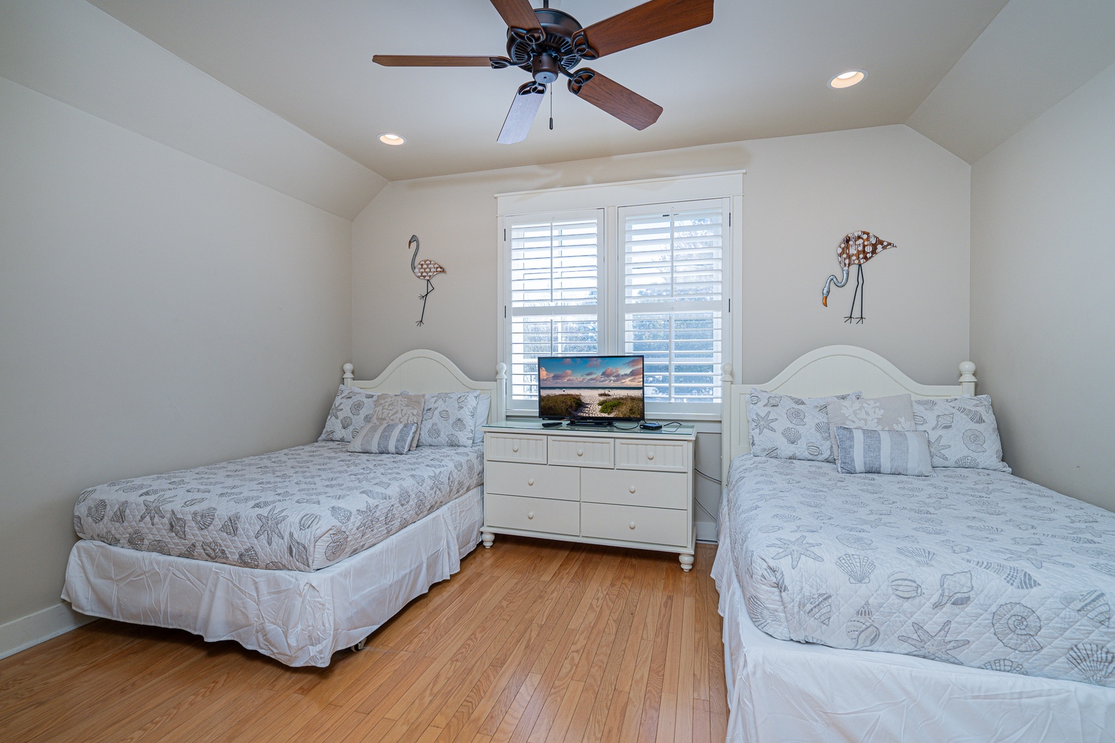This 2nd-floor bedroom features 2 full beds, 1 twin bed, & a private ensuite.