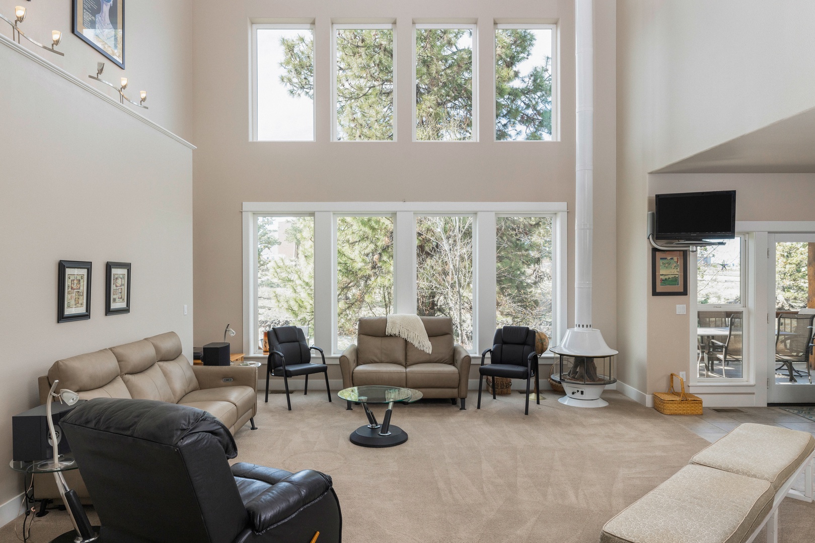 Bright living room with comfy seating, retro fireplace, canal view, and Smart TV