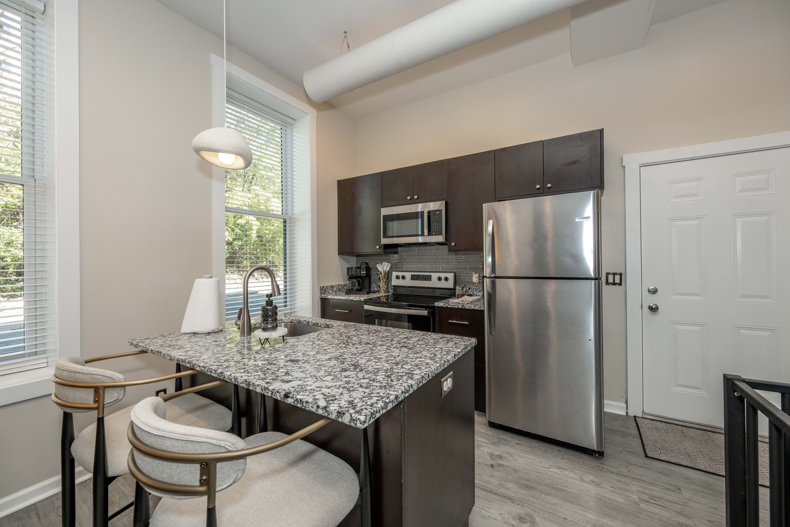 The chic, open kitchen offers loads of room & all the comforts of home