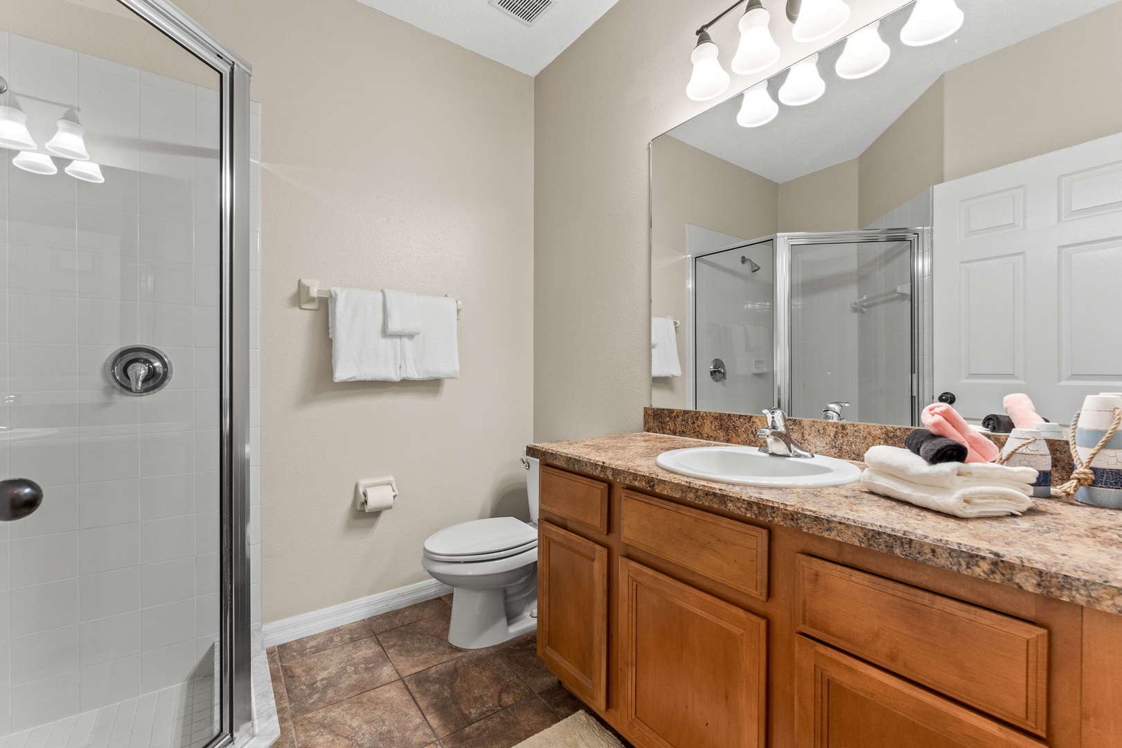 First floor shared bathroom featuring a spacious walk-in shower