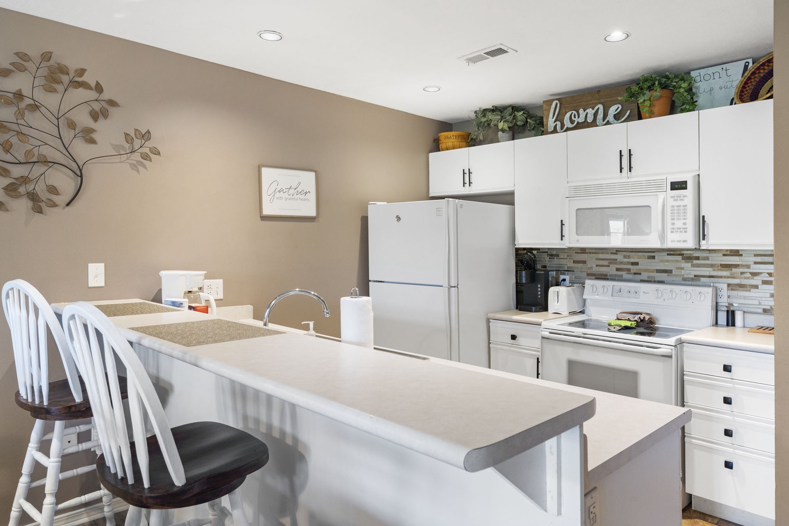 You’ll love taking morning coffee at the counter in this charming kitchen, equipped with a Keurig coffee maker