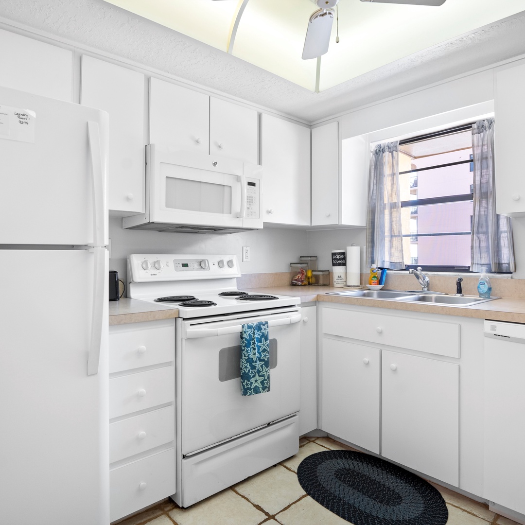 The sunny kitchen offers ample space & all the comforts of home