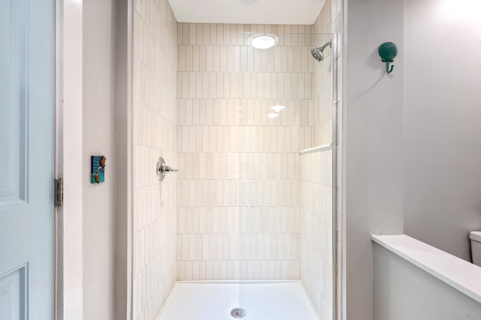 The shared main floor full bath includes a single vanity & walk-in shower