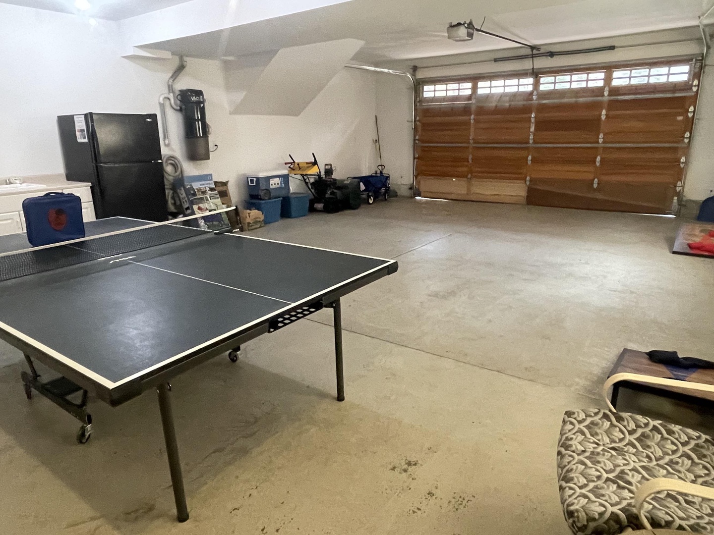 Garage with ping pong table and corn hole