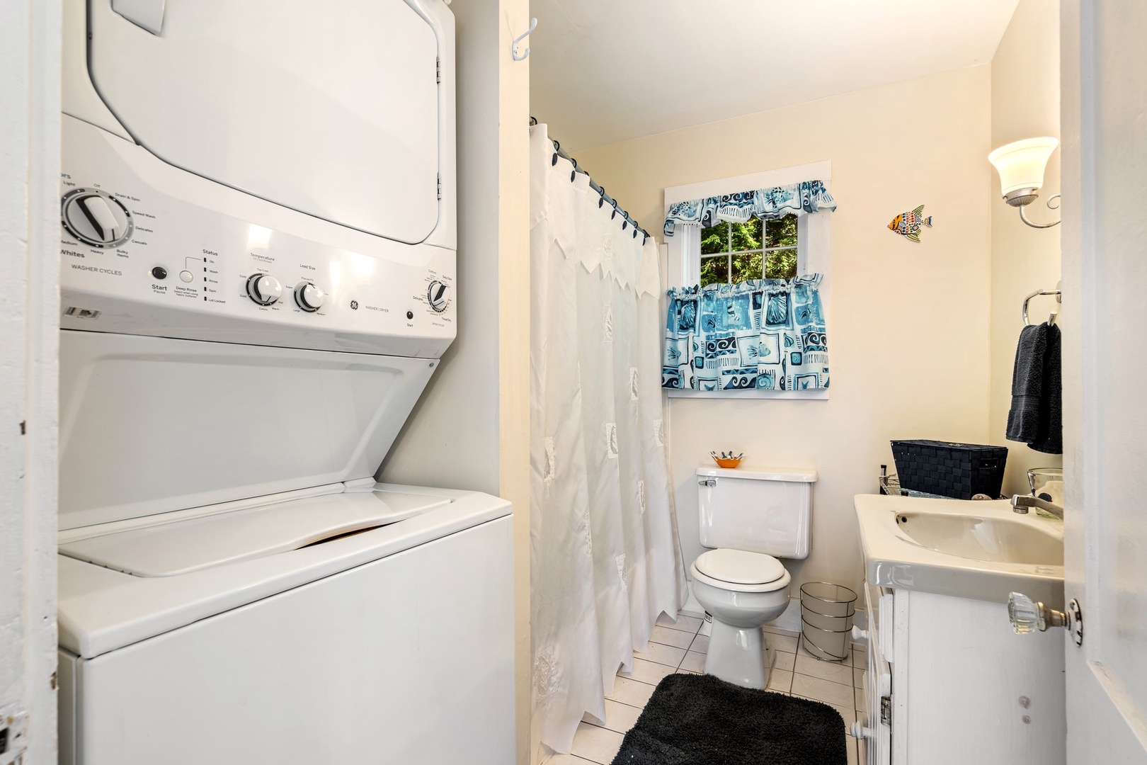 Shared bathroom with shower/tub combo and laundry area