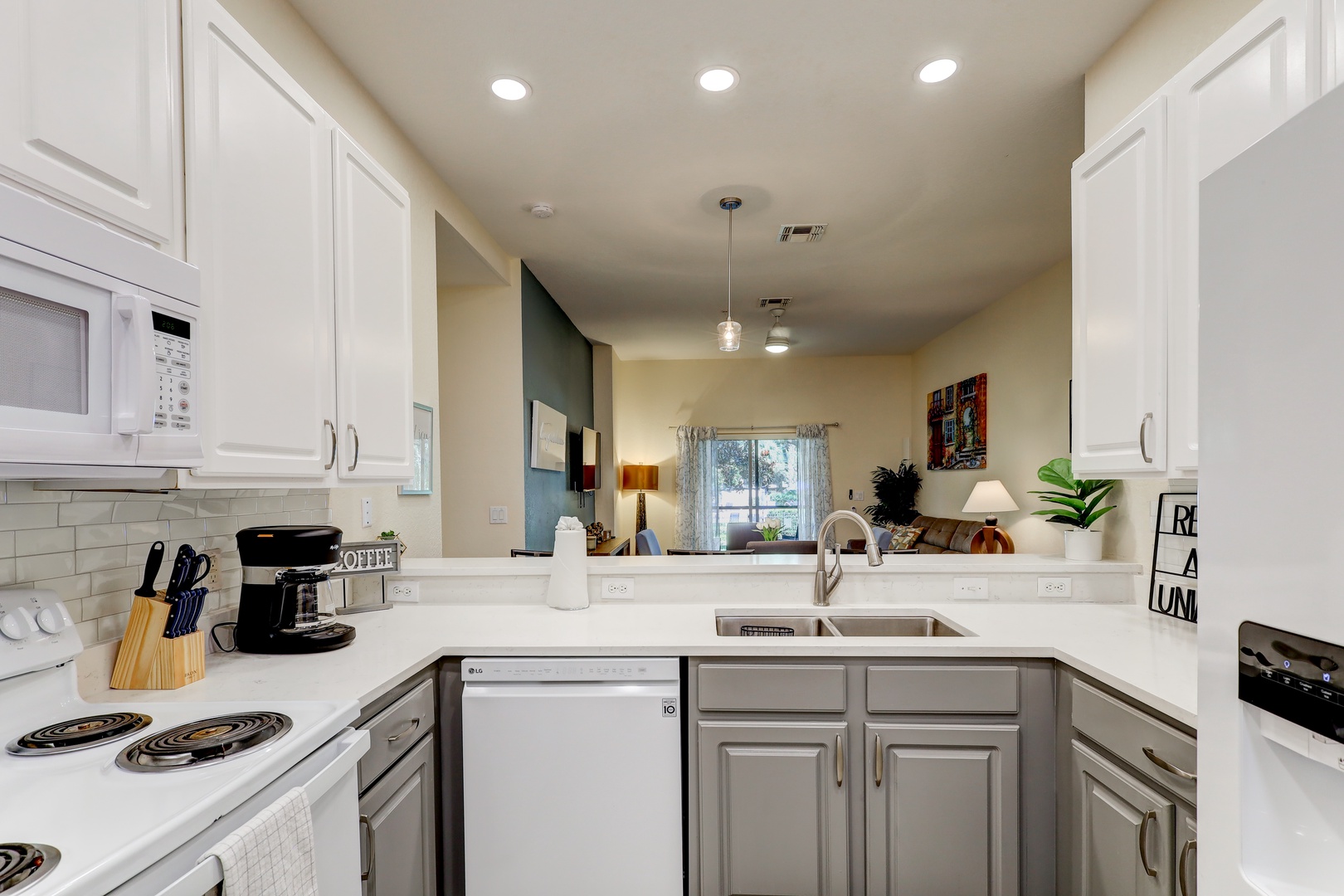 The sleek, open kitchen is well equipped with all the comforts of home