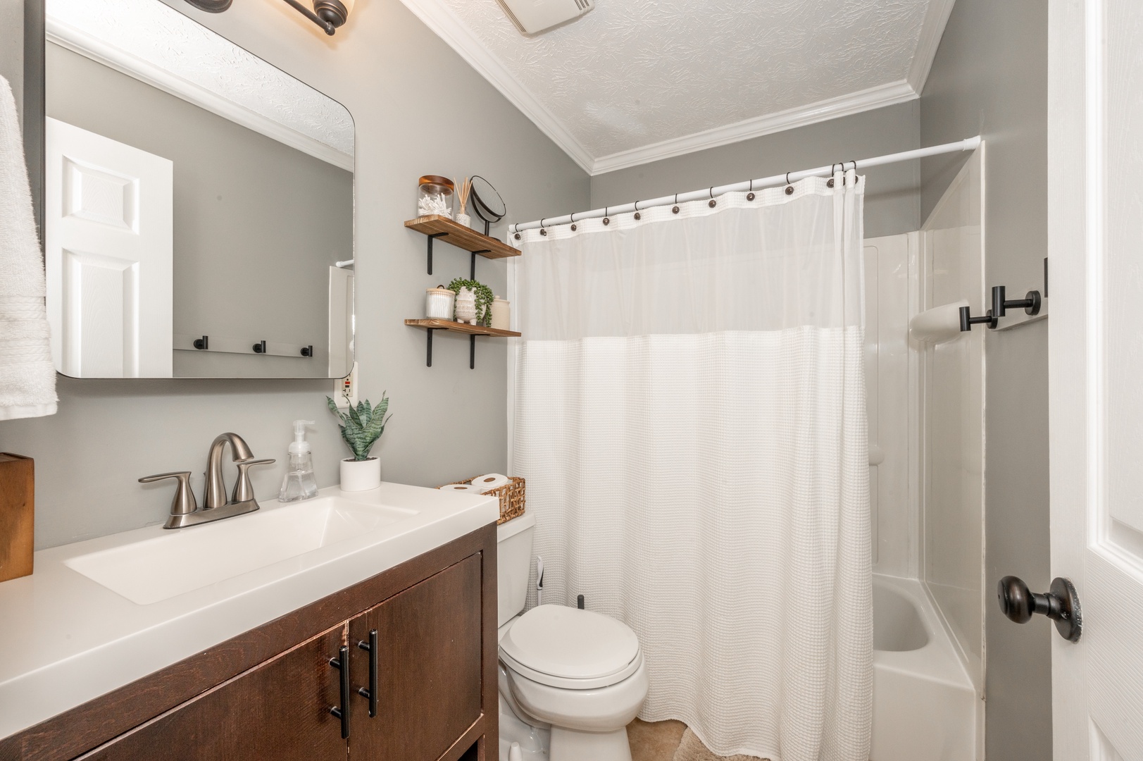 The upper-level full bathroom includes a single vanity & shower/tub combo