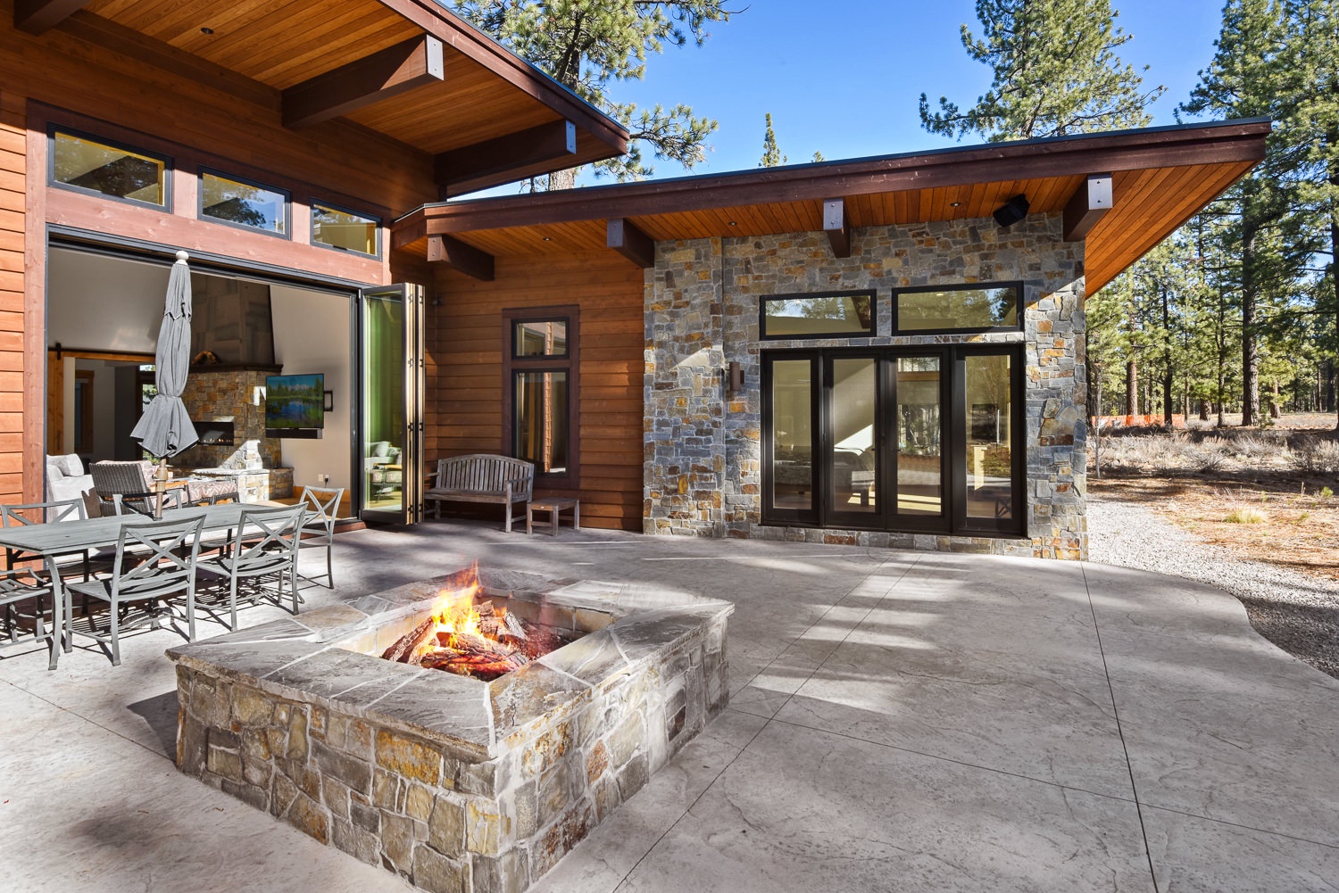 Large patio with gas fireplace, seating, and BBQ