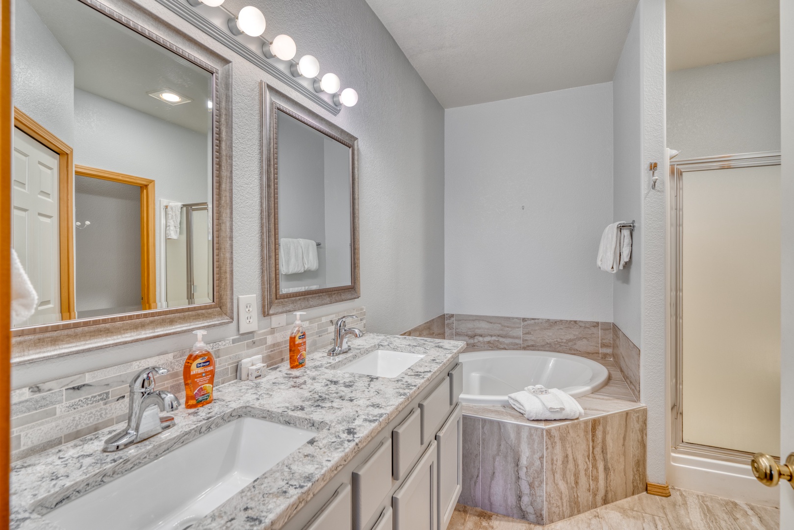 Prepare for the day in this ensuite, with dual vanities, shower, & soaking tub