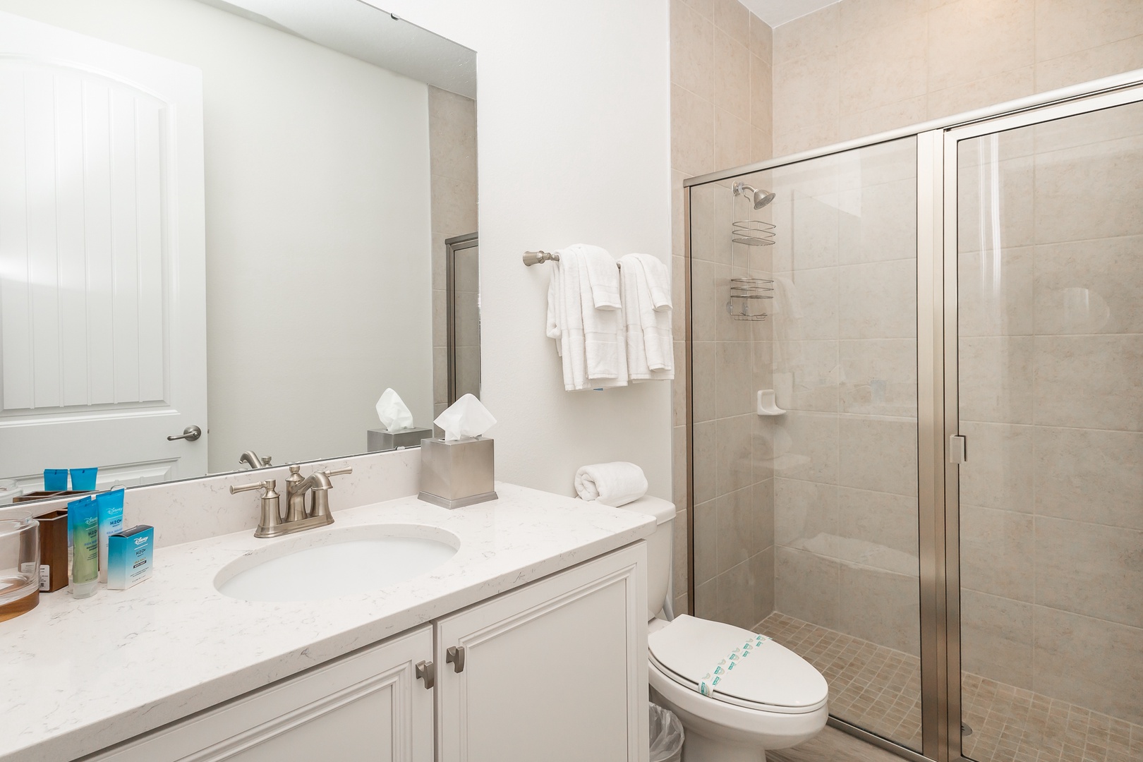 The 1st floor full bathroom offers a single vanity & glass shower