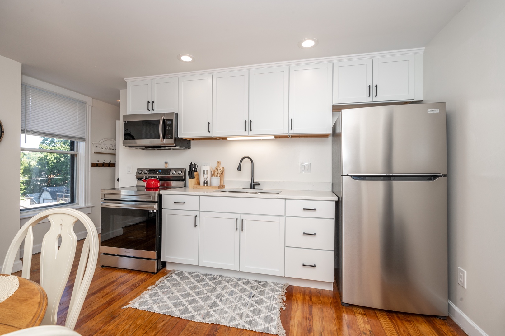 Step into Apartment B’s sunny kitchen, boasting plenty of space & amenities