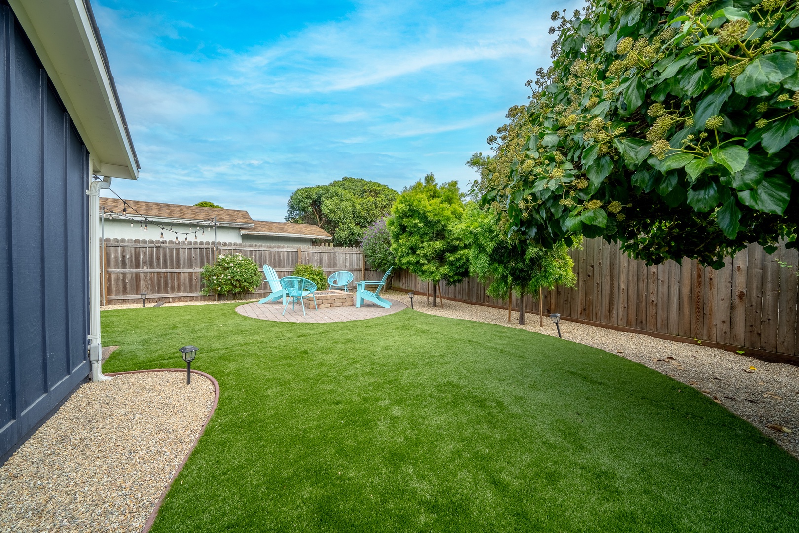 The spacious, enclosed back yard offers ample space for relaxation & play