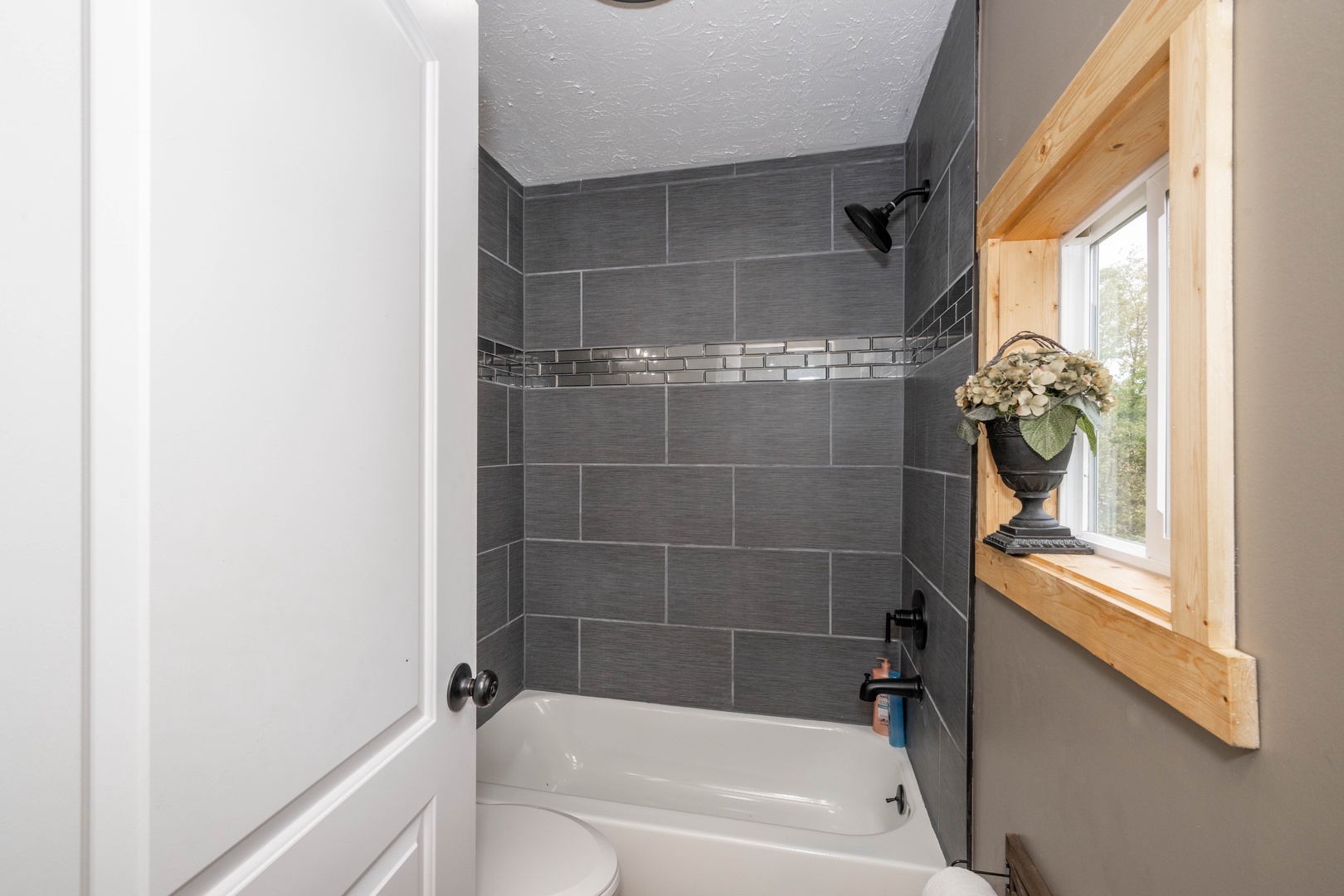 Wash up in the full bath, featuring a single vanity & shower/tub combo