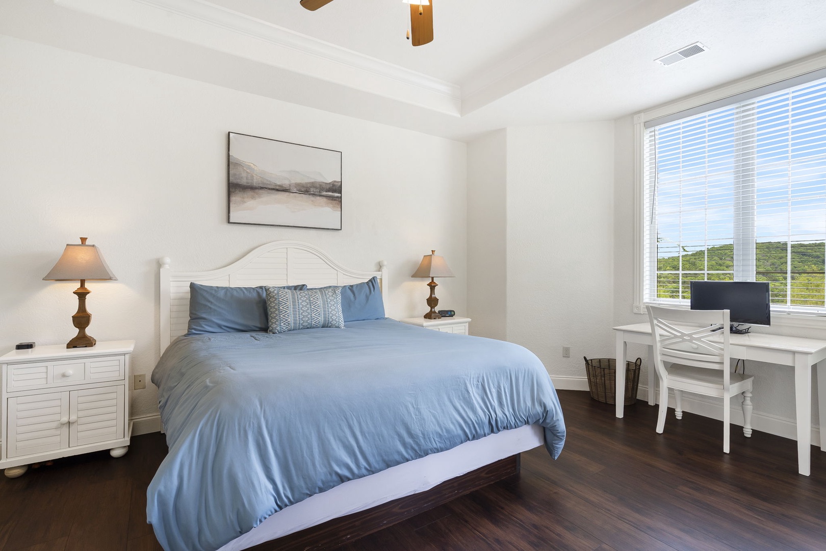 The king suite boasts serene views, private en suite, Smart TV, & patio access