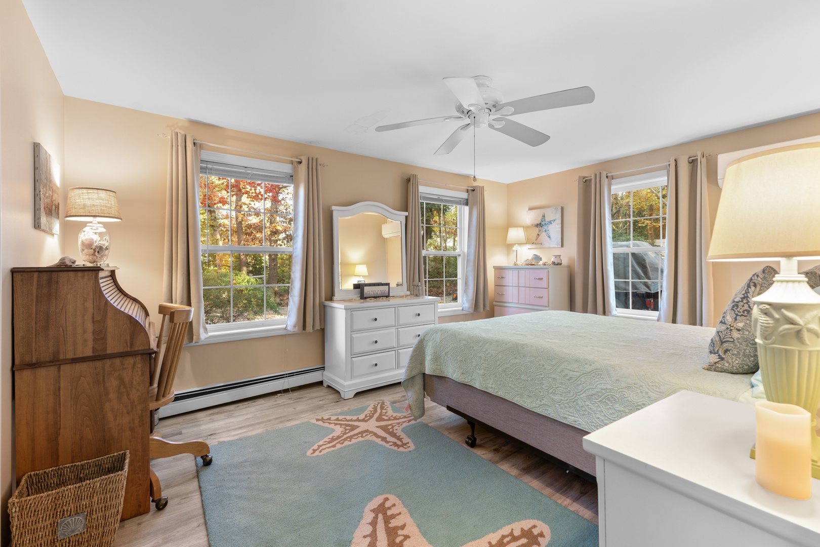 This 2nd floor bedroom offers a queen bed, desk workspace, & ceiling fan