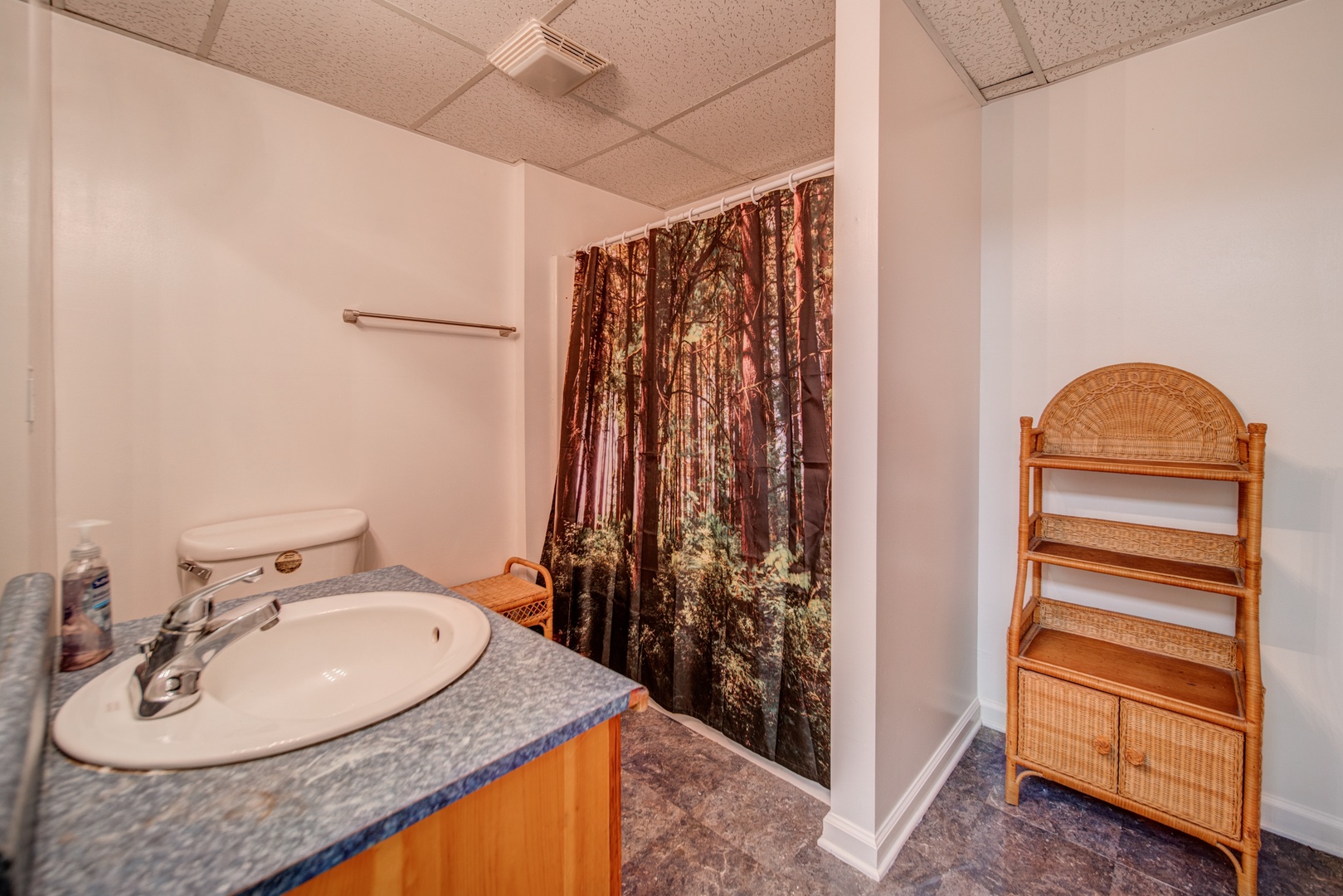 This full bath off the game room offers a single vanity & shower/tub combo