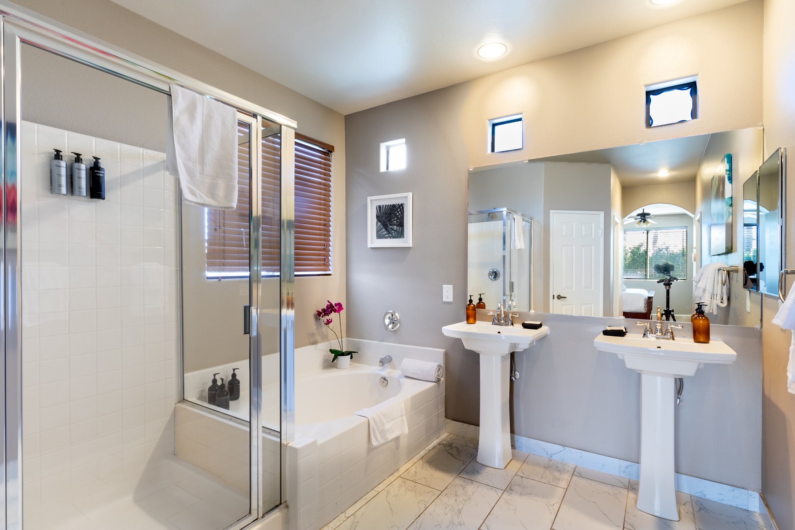 Private en-suite with stand dual sinks, up shower, and separate tub