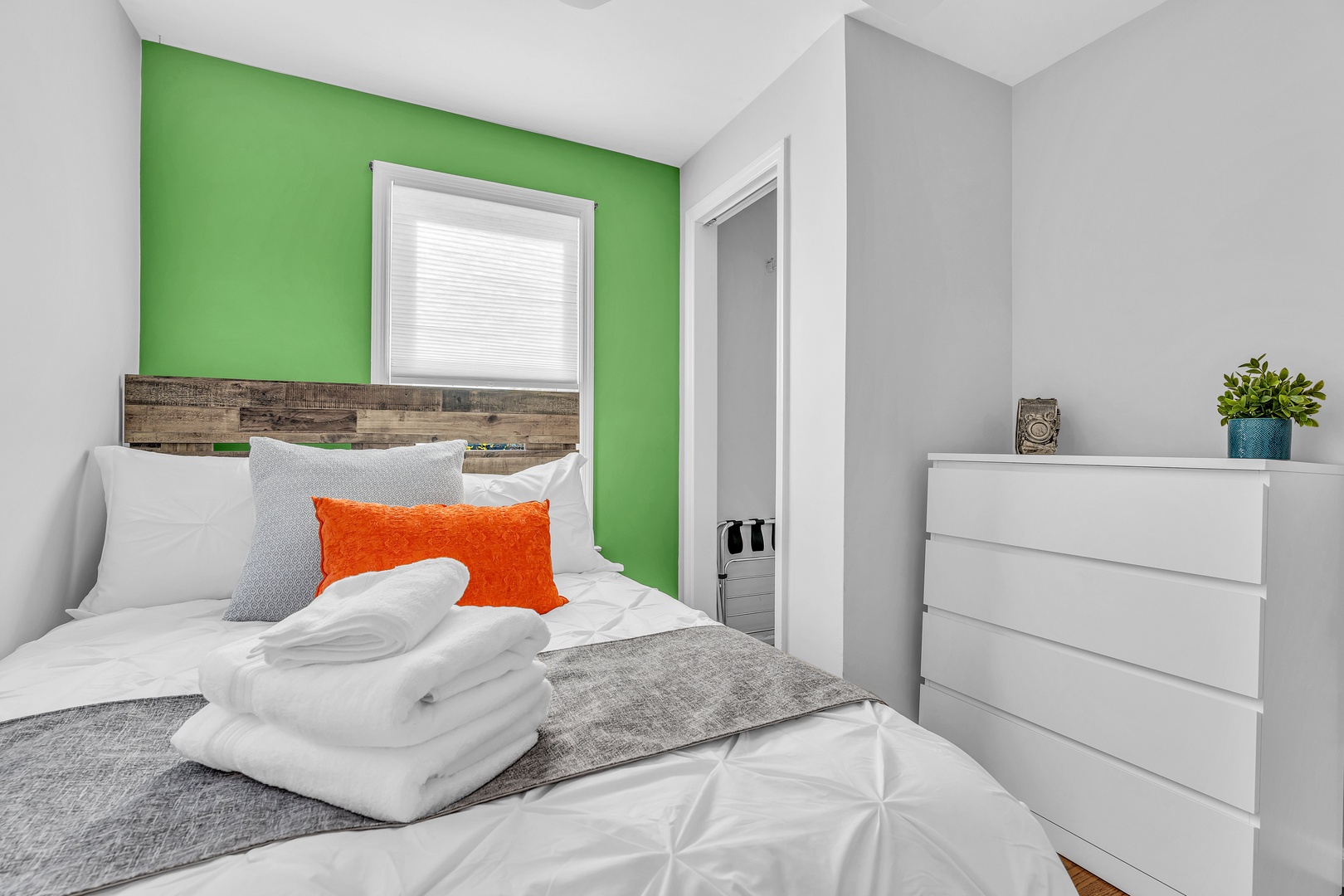 A cozy full-sized bed awaits in this colorful 2nd-floor bedroom
