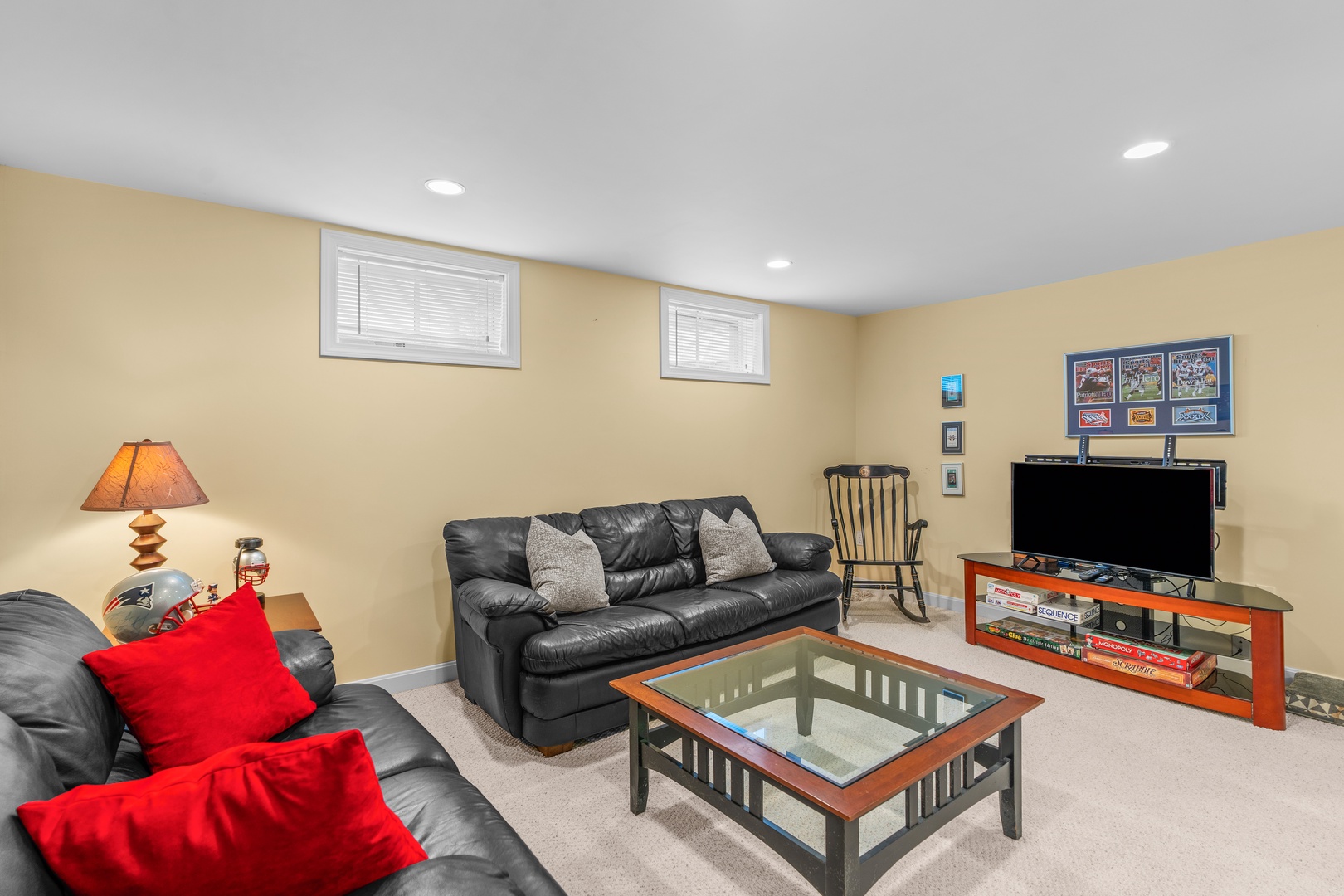 Spacious basement with leather sofas, and TV
