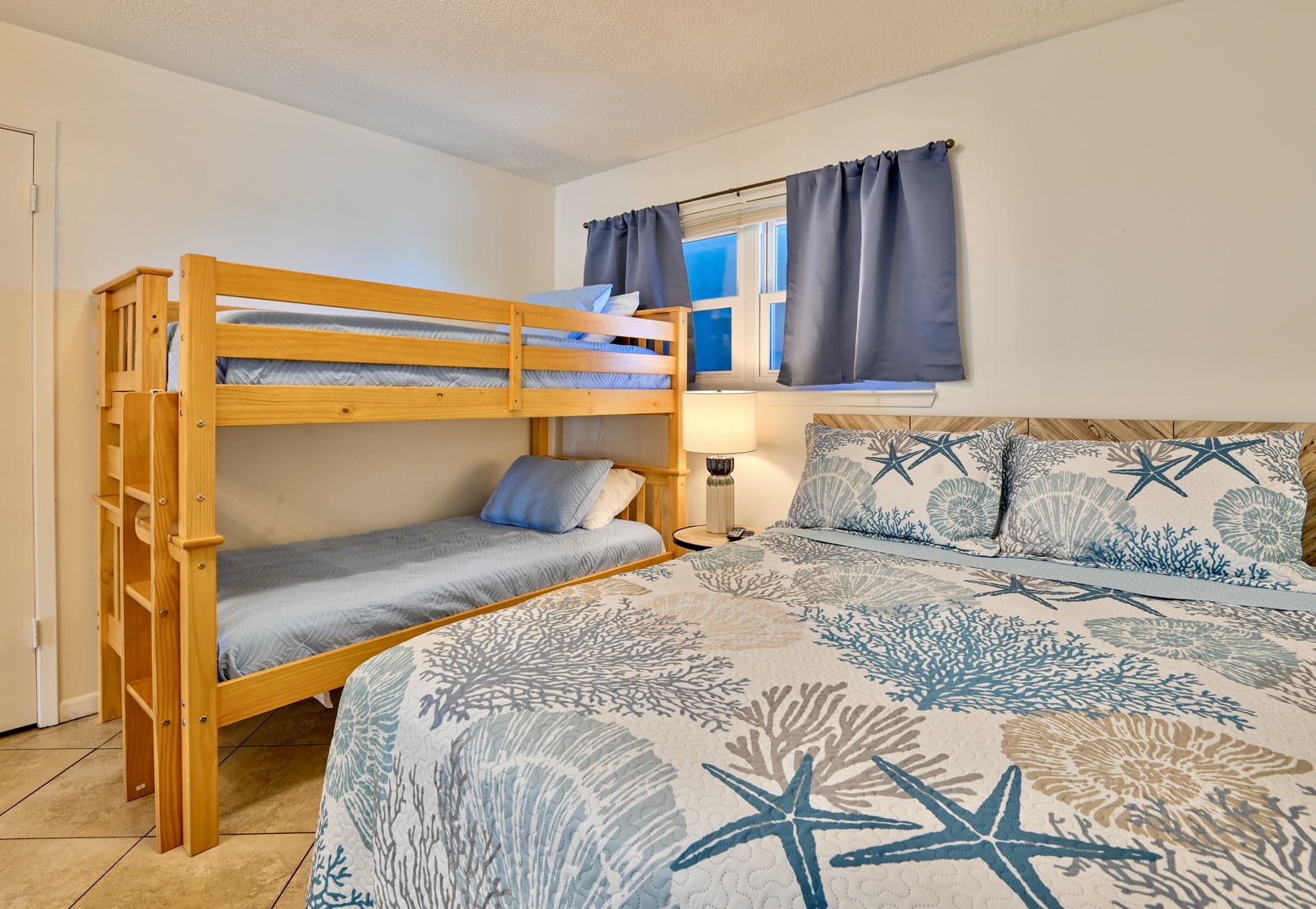 Bedroom 1 with twin/twin bunk bed, queen bed, Smart TV, and en-suite