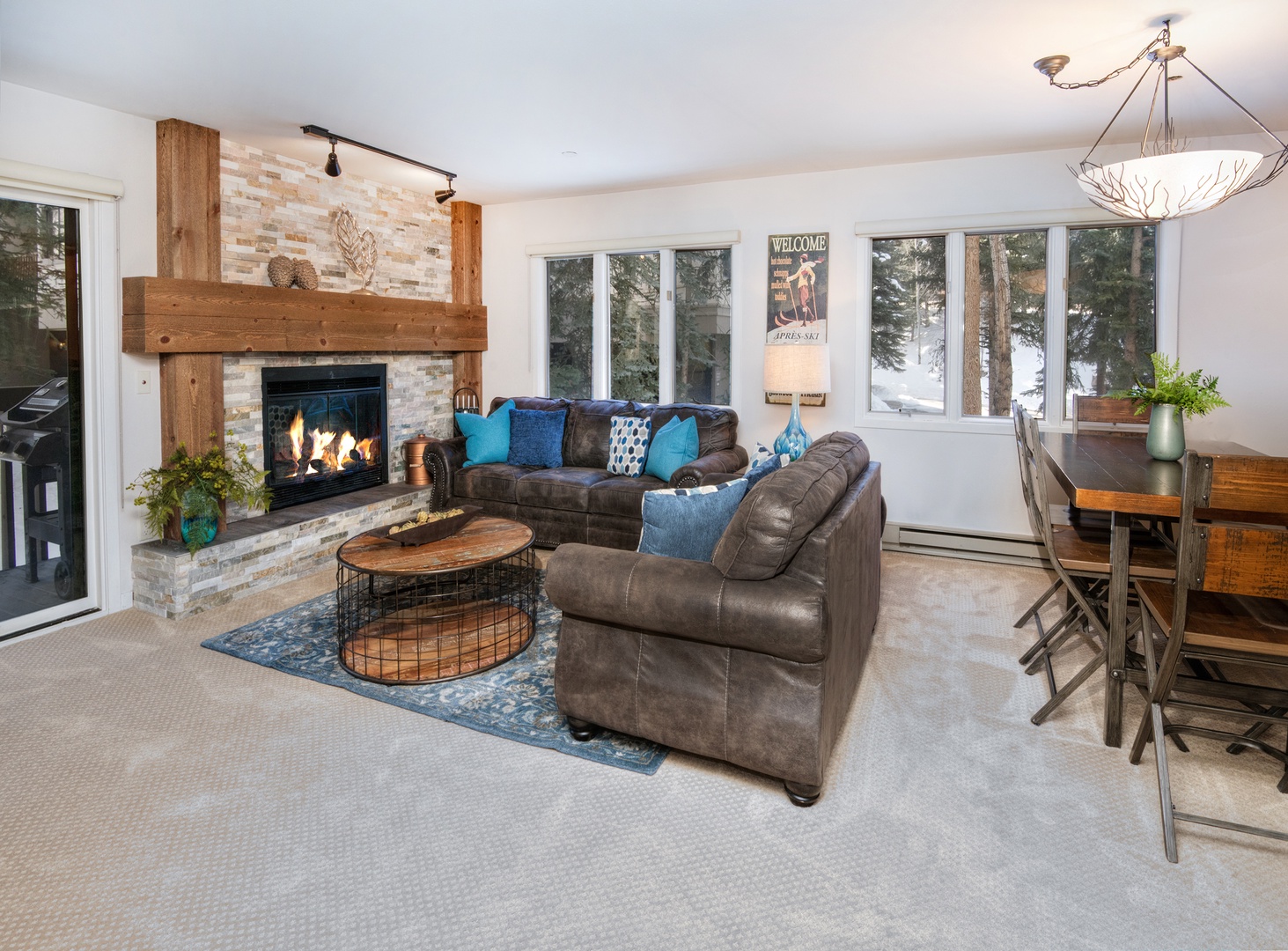 Bright living area with queen sofa sleeper, fireplace, balcony, and Smart TV