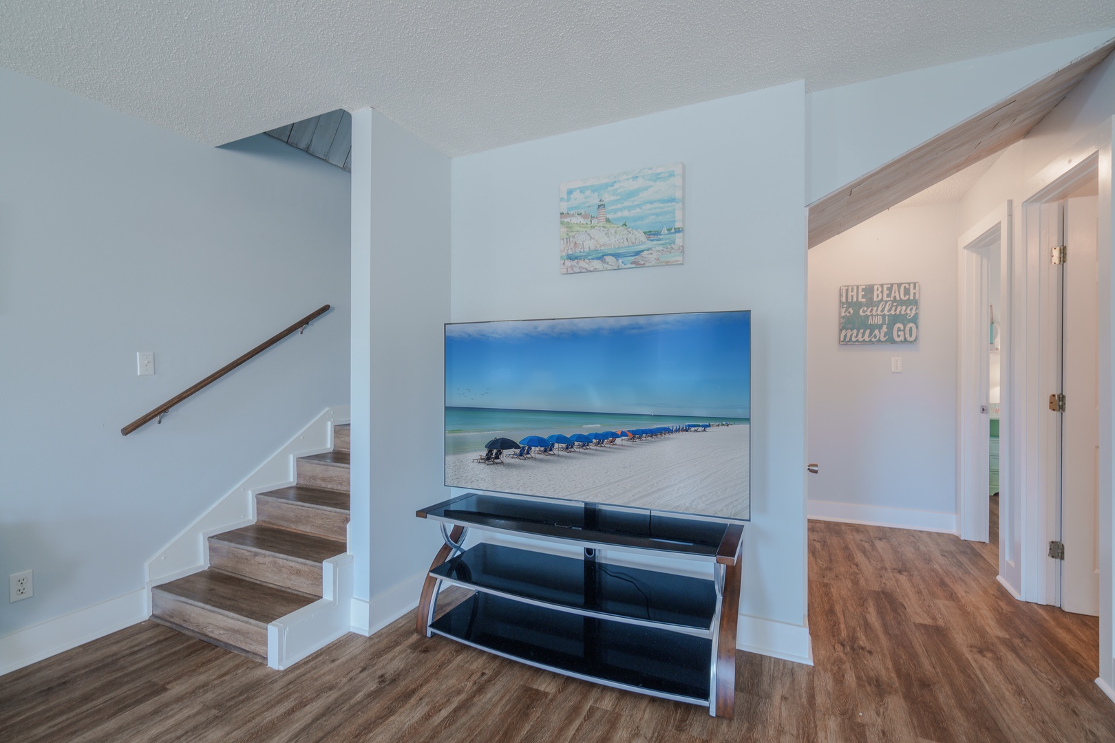 Staircase leading to the second floor beside the TV