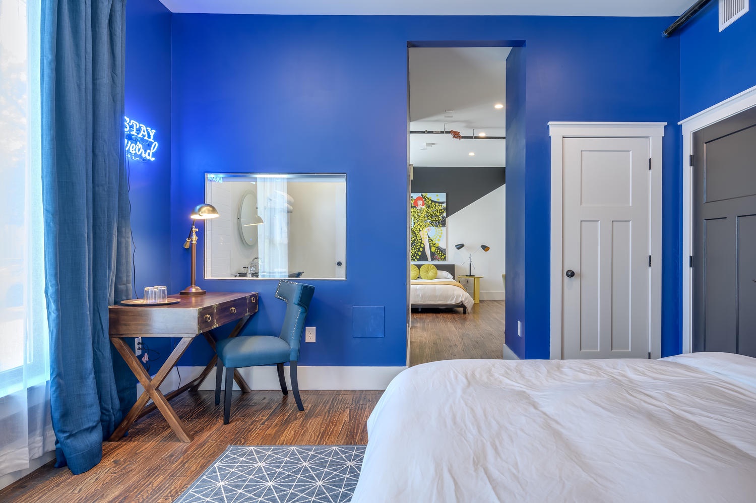 Suite 102 – The 1st Floor Blue Kusama Suite offers King and Queen Casper Beds, Smart TV, Patio Access, and private Bathroom