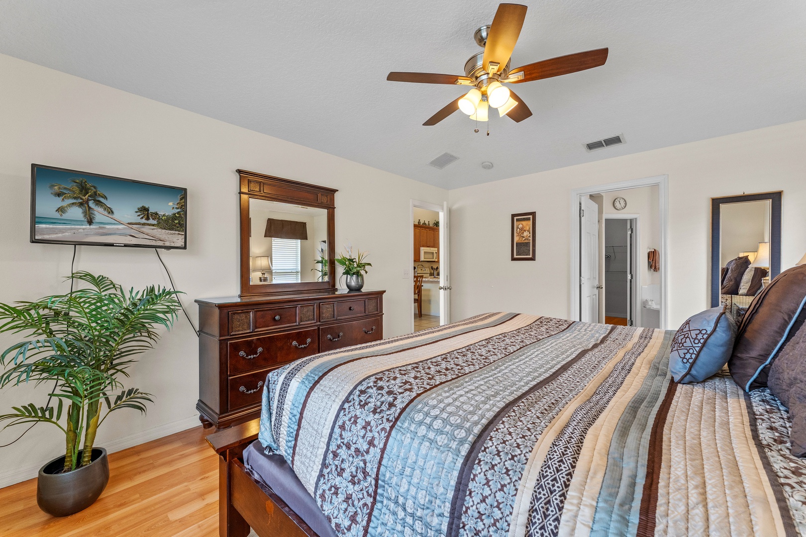 Cozy bedroom with queen bed, Smart TV, ceiling fan and ensuite