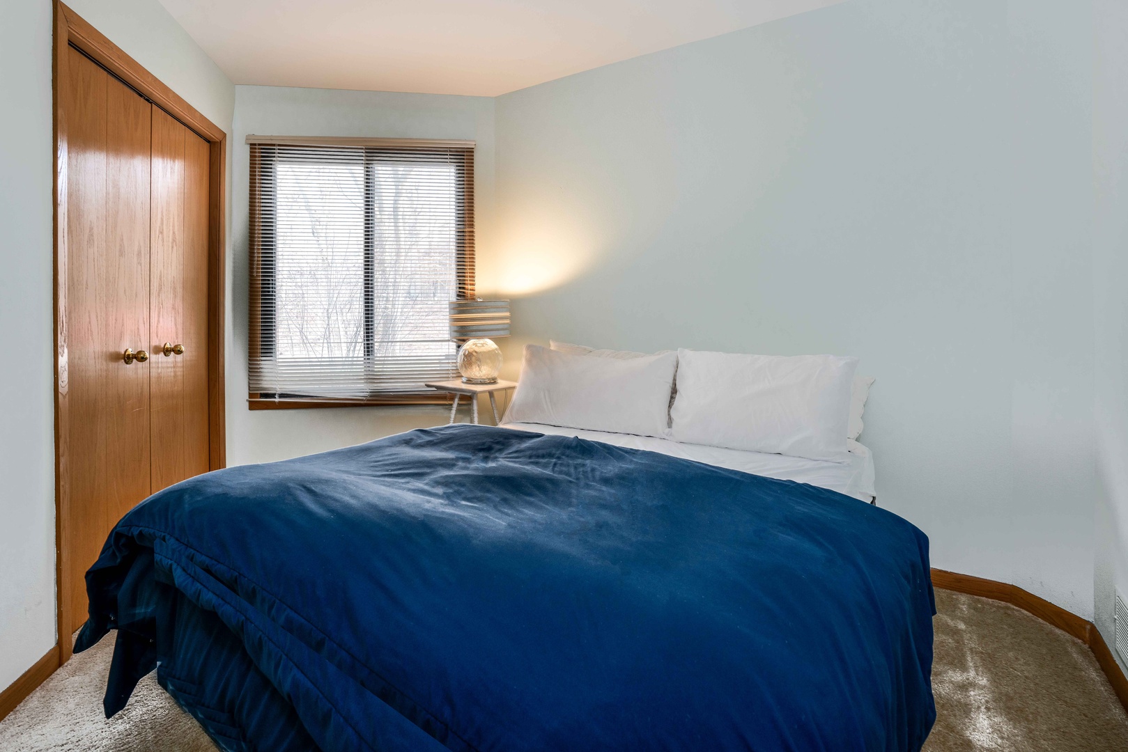 Unwind in the second bedroom furnished with queen bed & closet