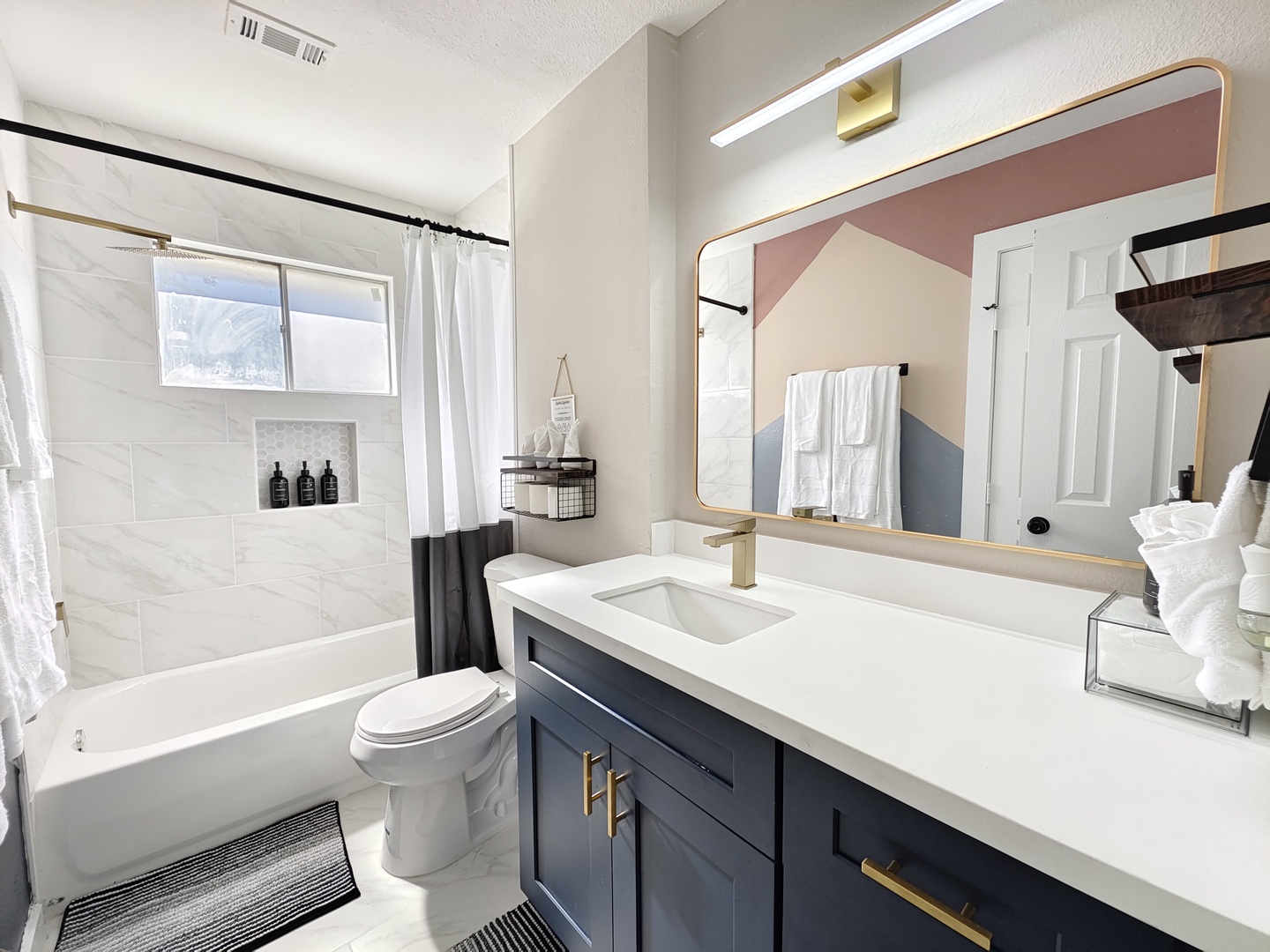 This full bathroom offers a large single vanity & shower/tub combo