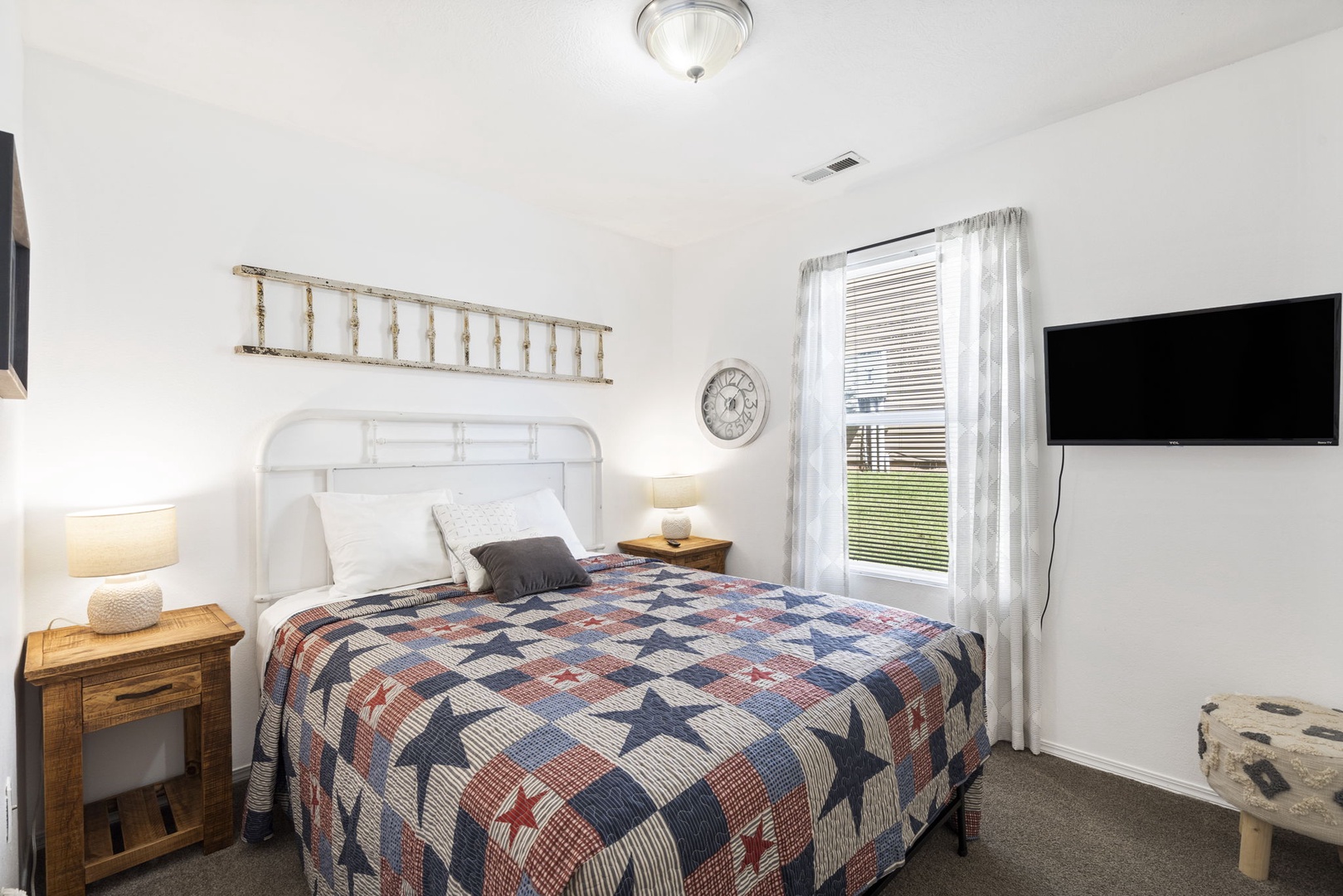 The second bedroom offers guests a queen bed & Smart TV