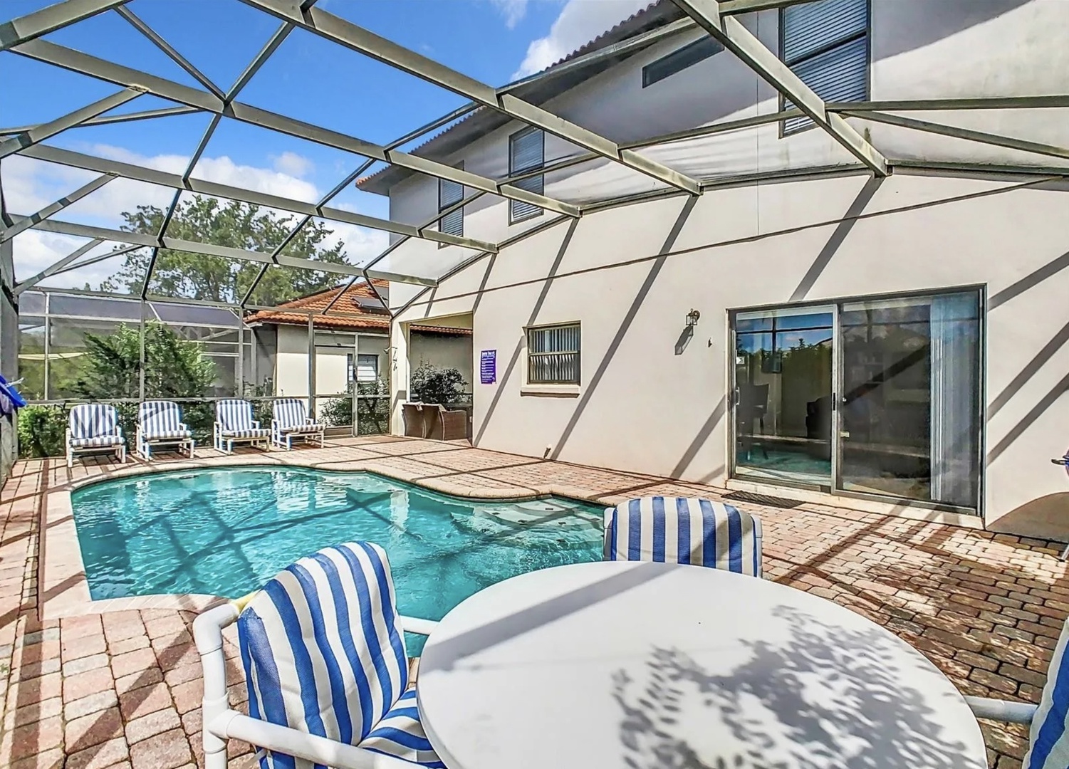 Private fenced in pool with outdoor seating