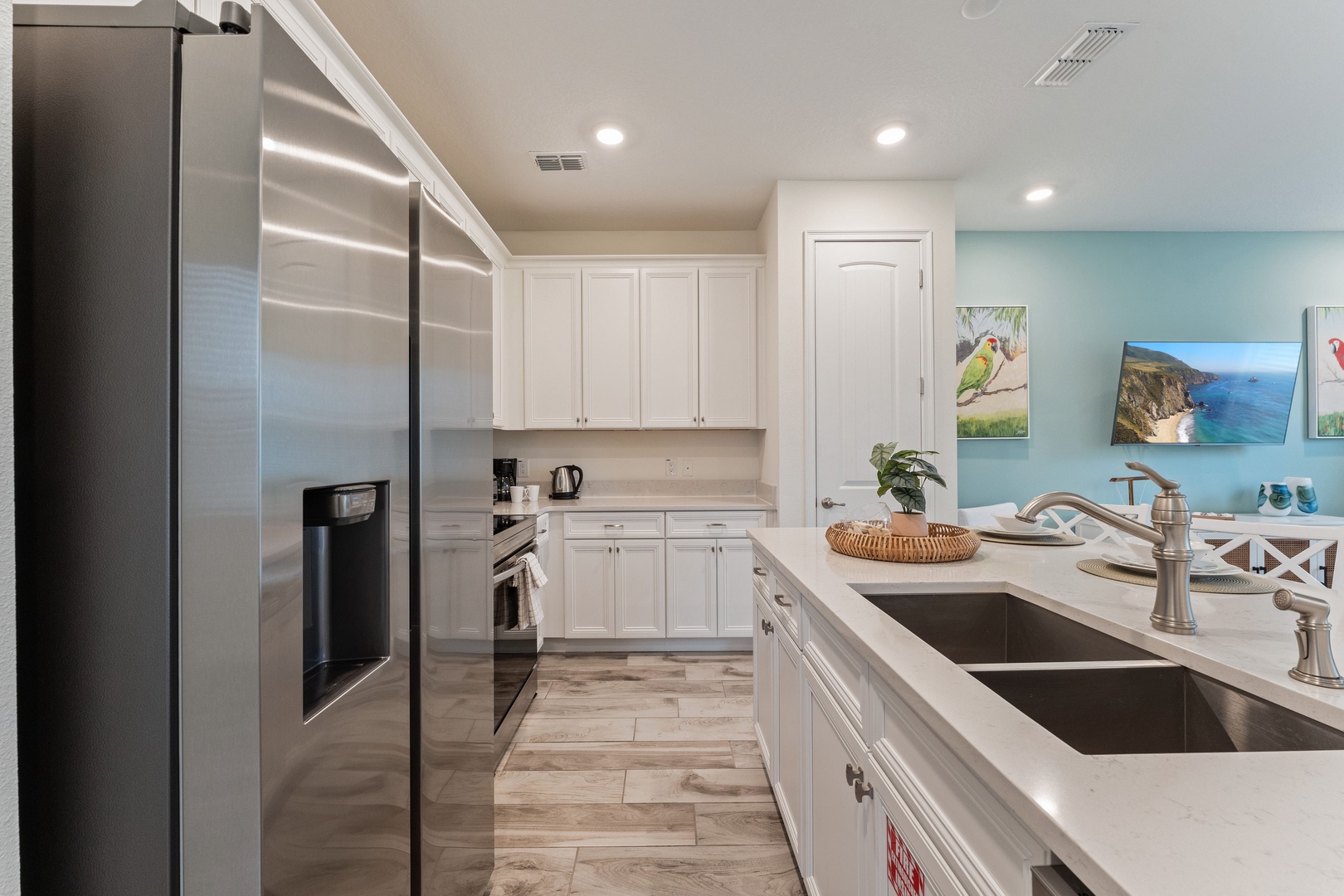 The sleek kitchen offers ample storage space & all the comforts of home