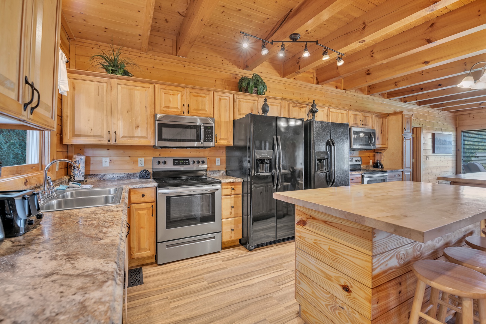 The gorgeous, rustic kitchen offers ample space & all the comforts of home