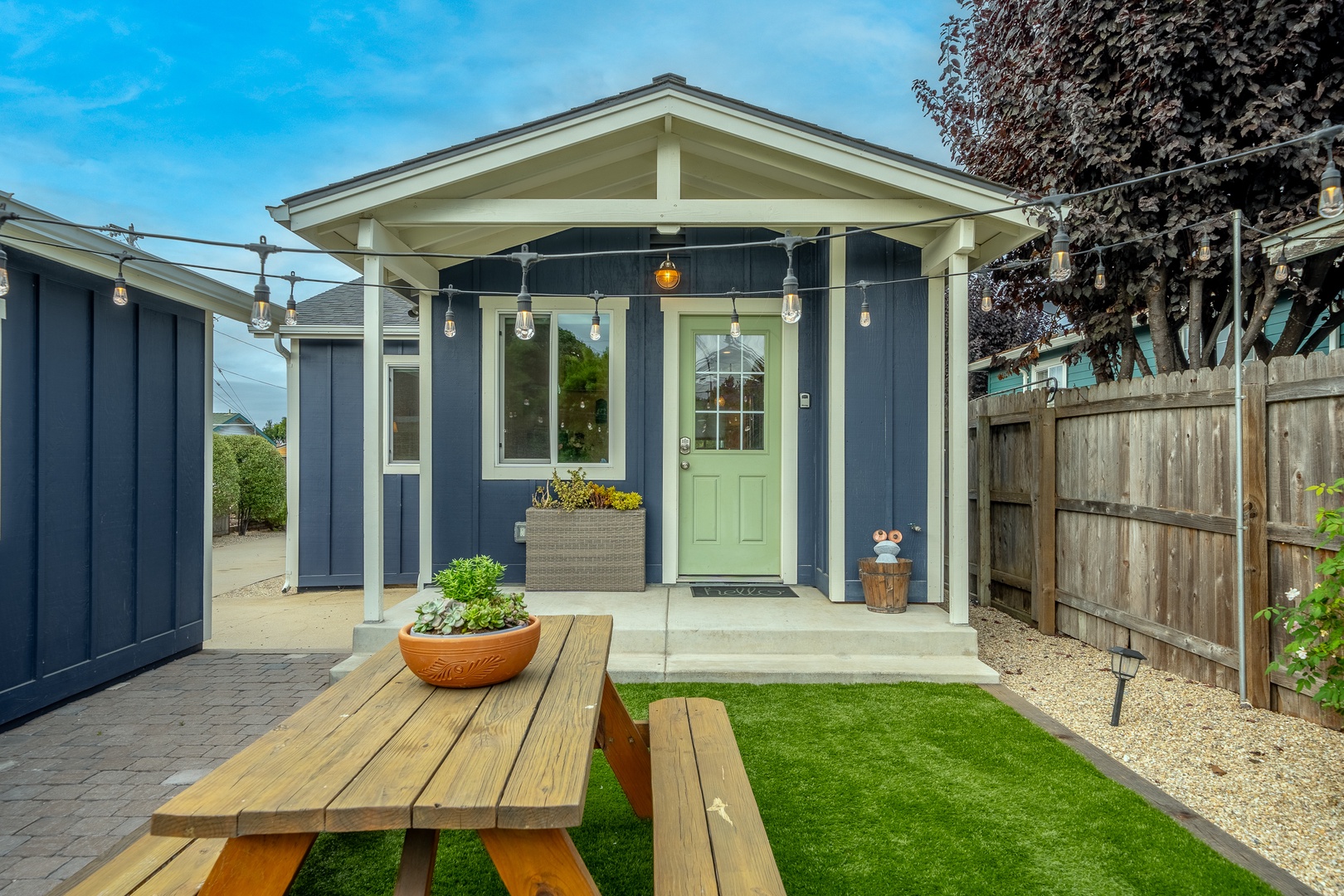 The spacious, enclosed back yard offers ample space for relaxation & play
