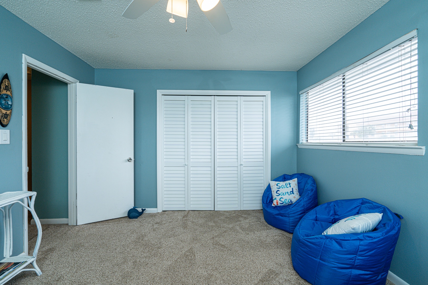 The 1st of 2 upper-level bedrooms is ideal for kids, featuring twin beds & a Smart TV