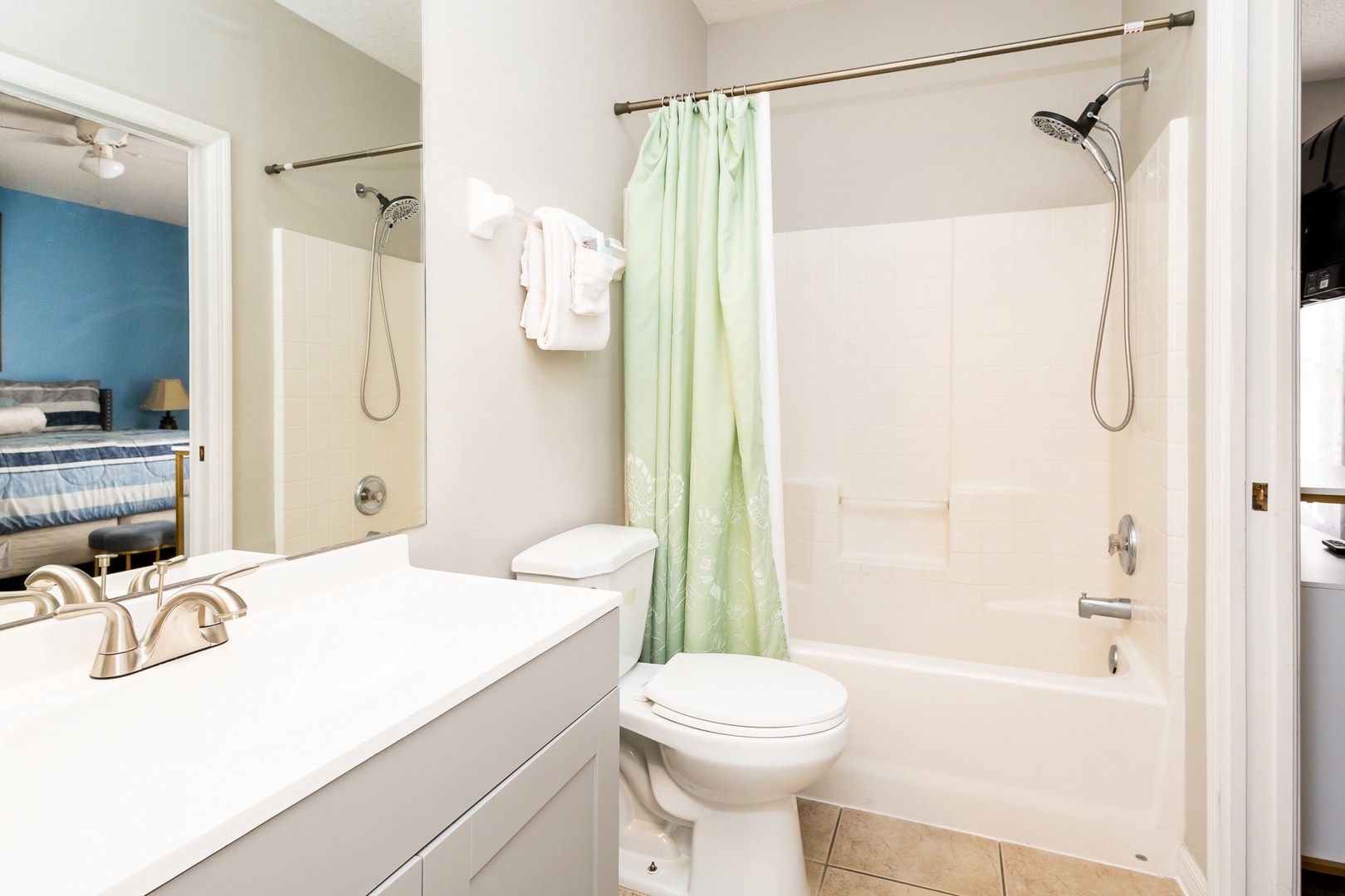 Wash up in this ensuite, featuring a single vanity & shower/tub combo