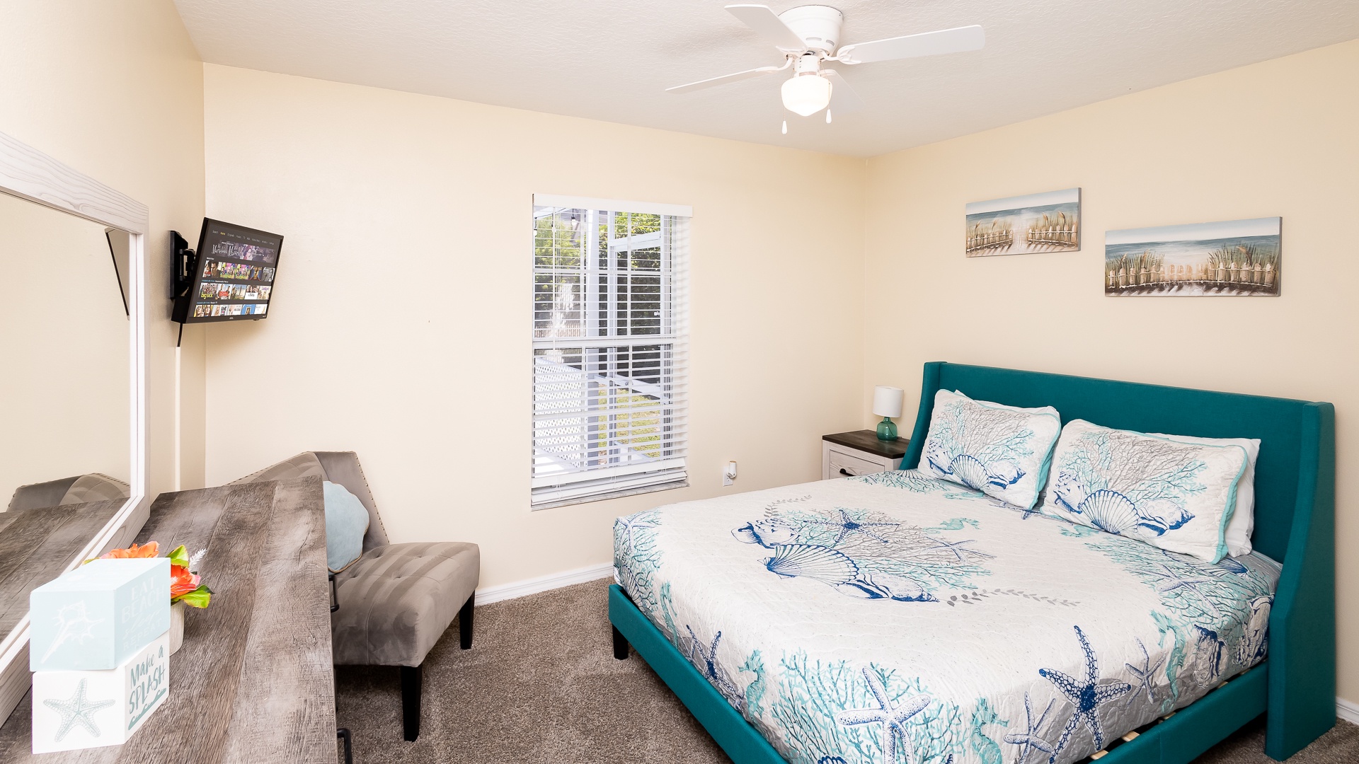 This comfy queen bedroom includes a smart TV and ceiling fan