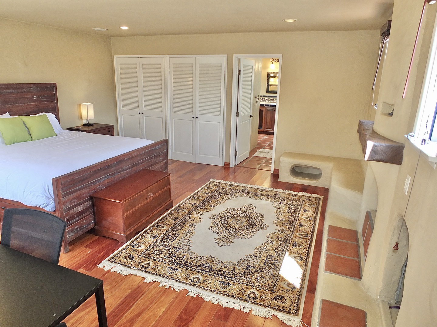 The spacious 2nd floor bedroom offers a king bed, deck access, & private en suite