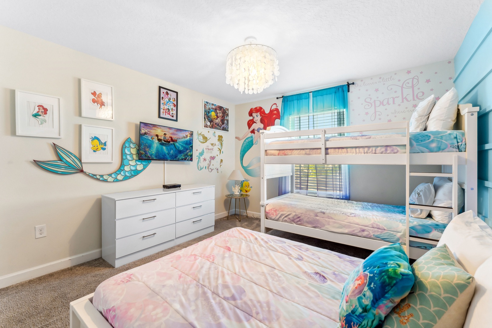 This  cozy Little Mermaid bedroom featuring a twin bunkbed and full-size bed