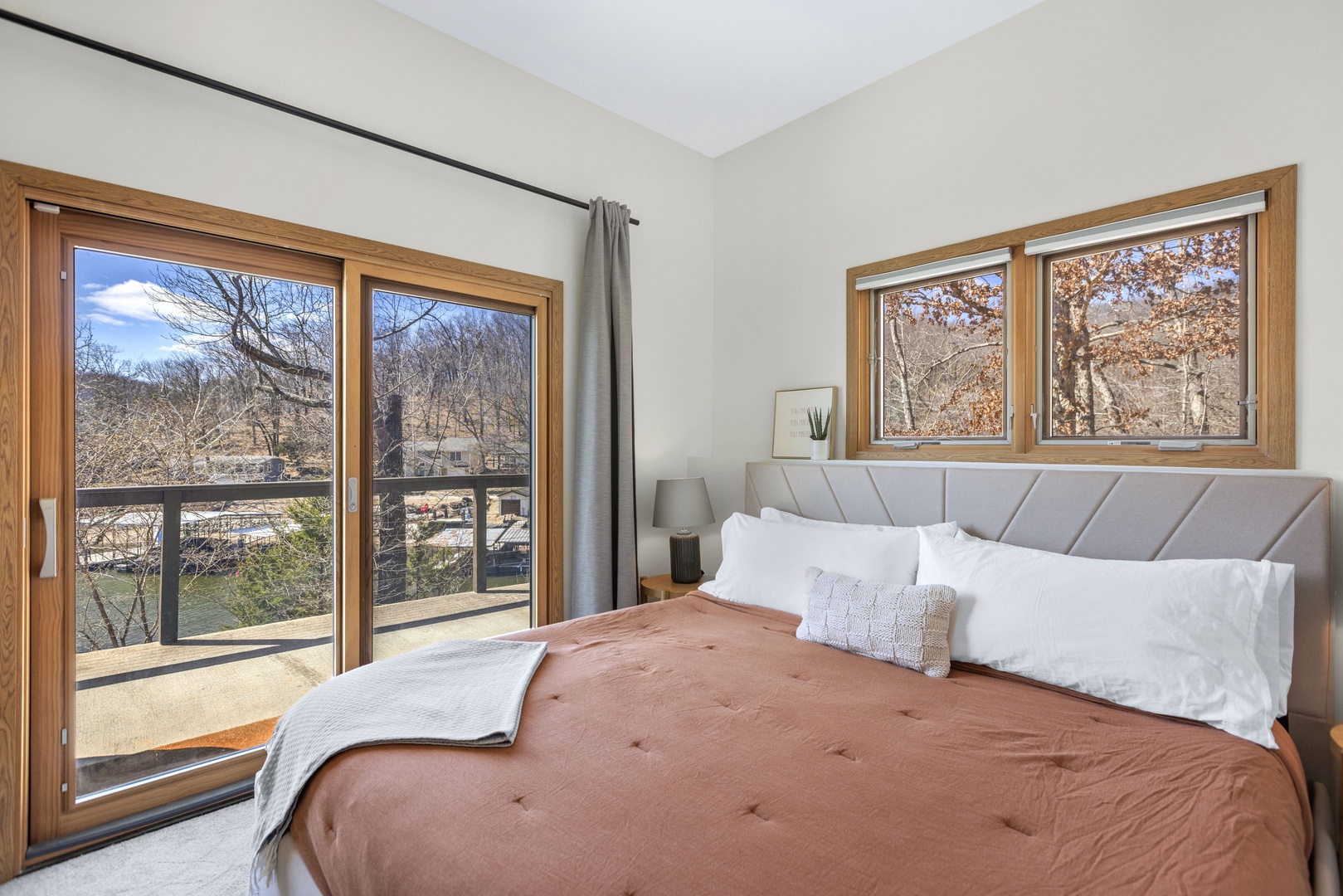 This serene bedroom includes a cozy king bed & deck access
