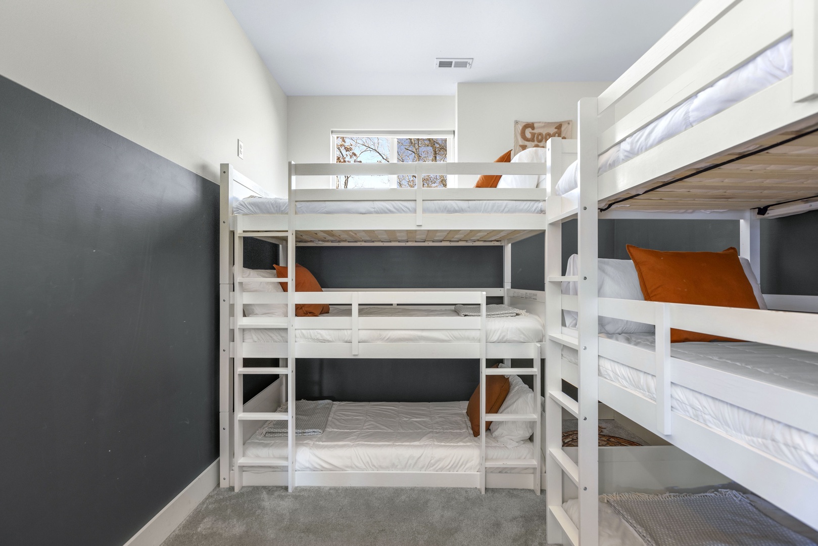 The second bedroom includes a pair of triple twin bunkbeds