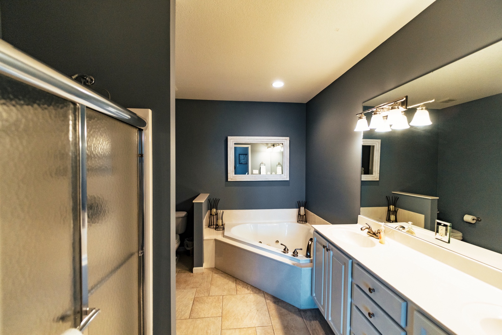 The master ensuite offers a double vanity, shower, & jetted soaking tub