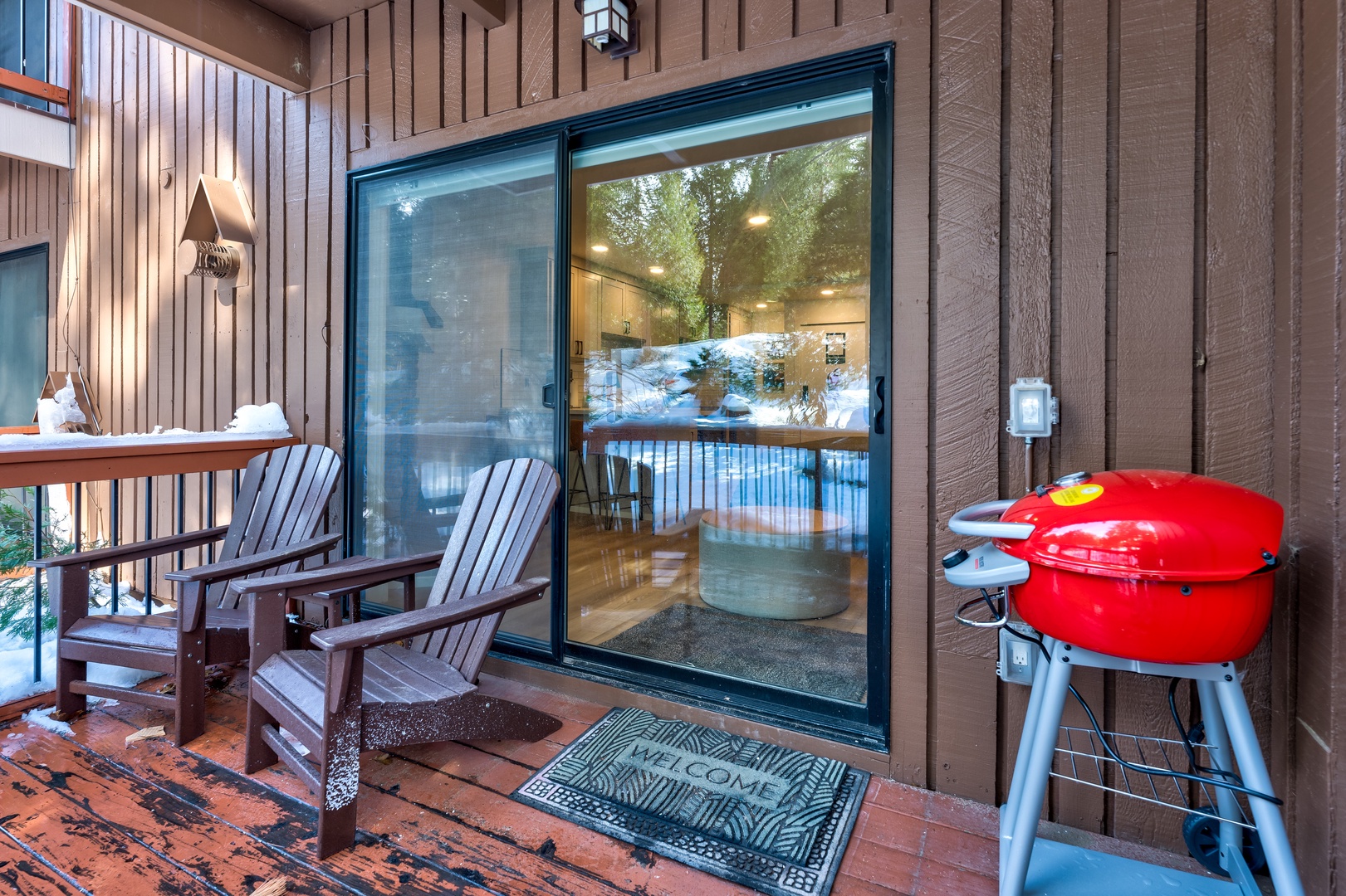 Private deck with outdoor seating and grill