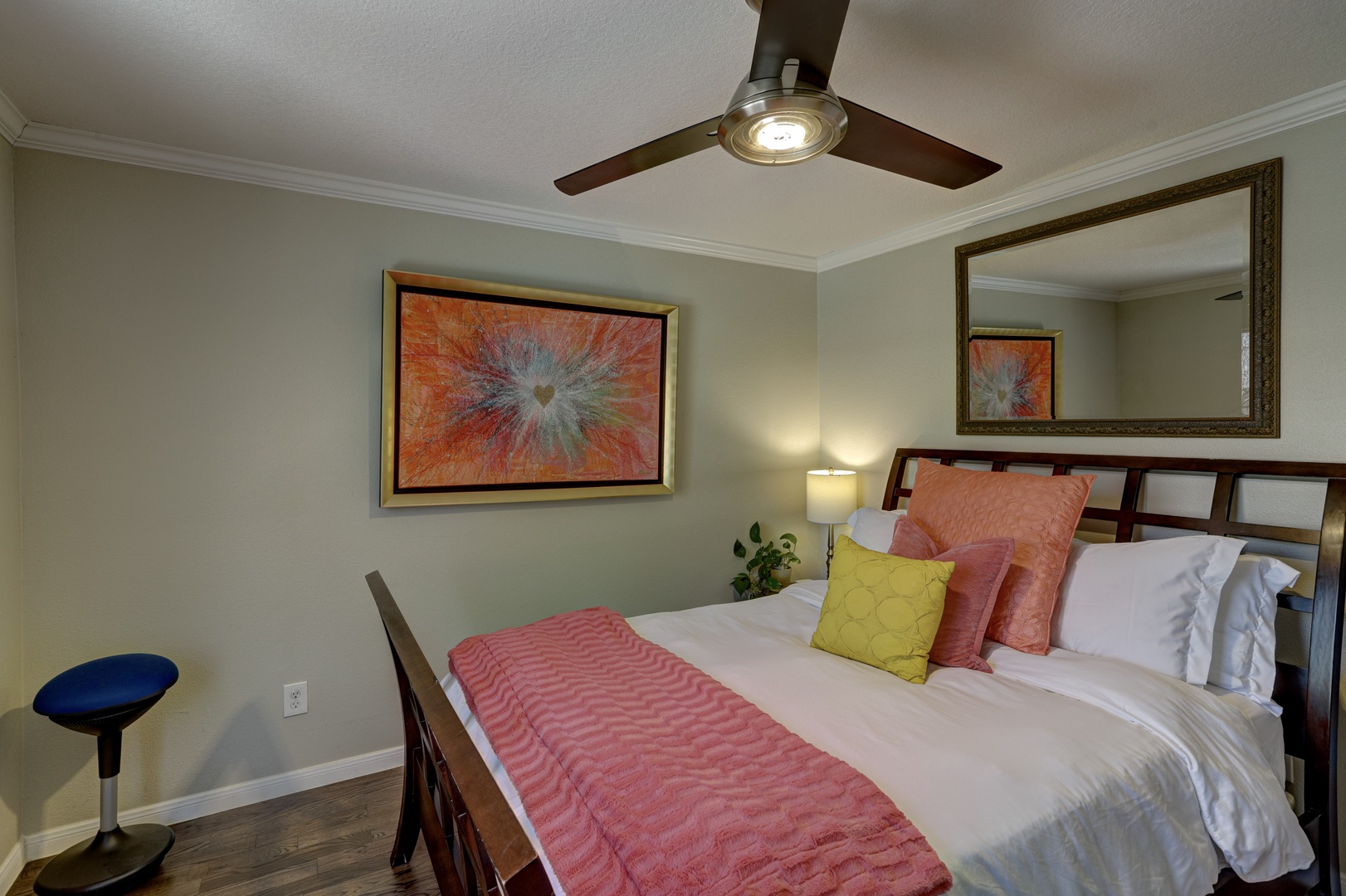 A cozy queen bed & ample natural light await in this bedroom retreat