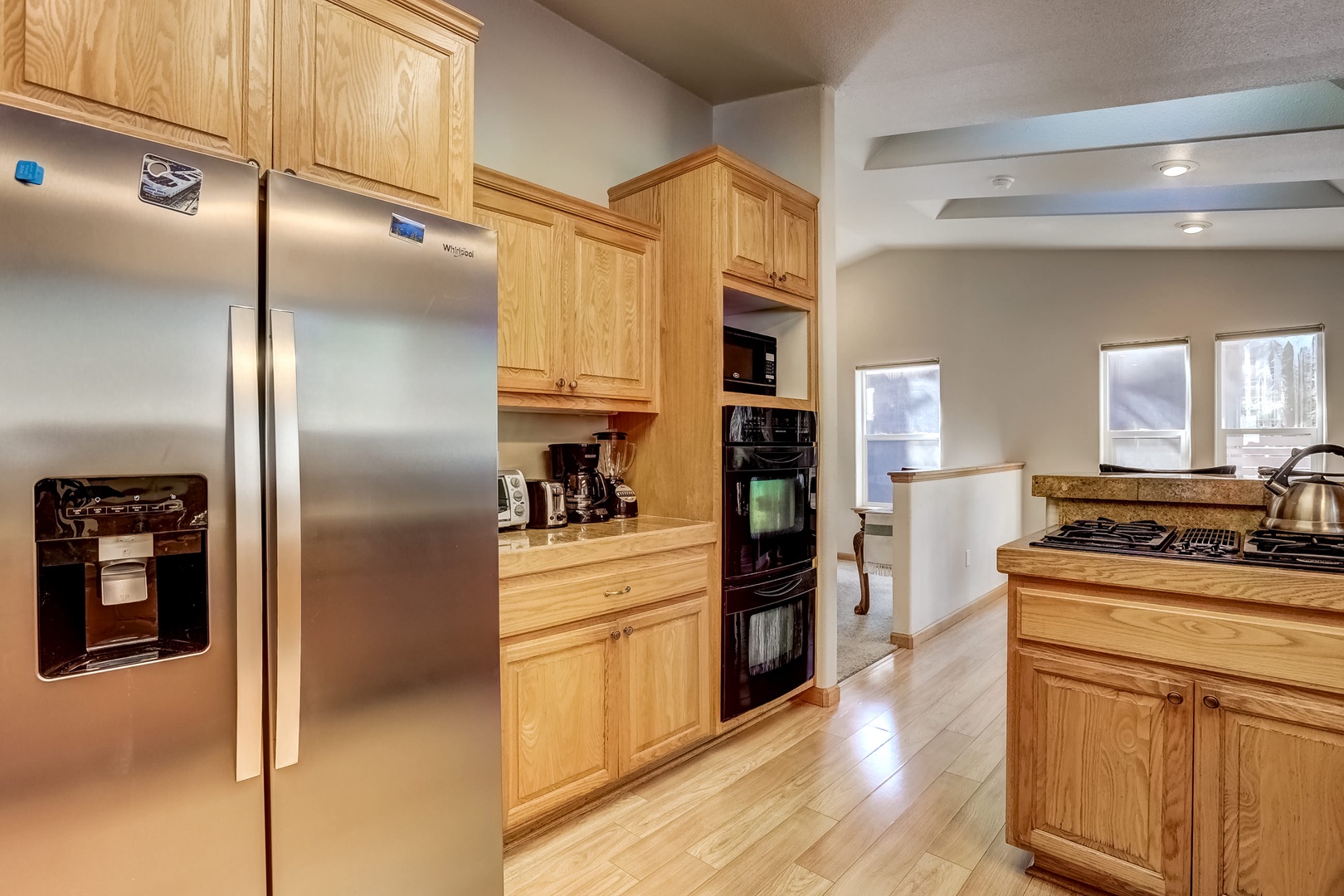 Kitchen with drip coffee maker, toaster oven, blender, waffle maker, slow cooker, and more!