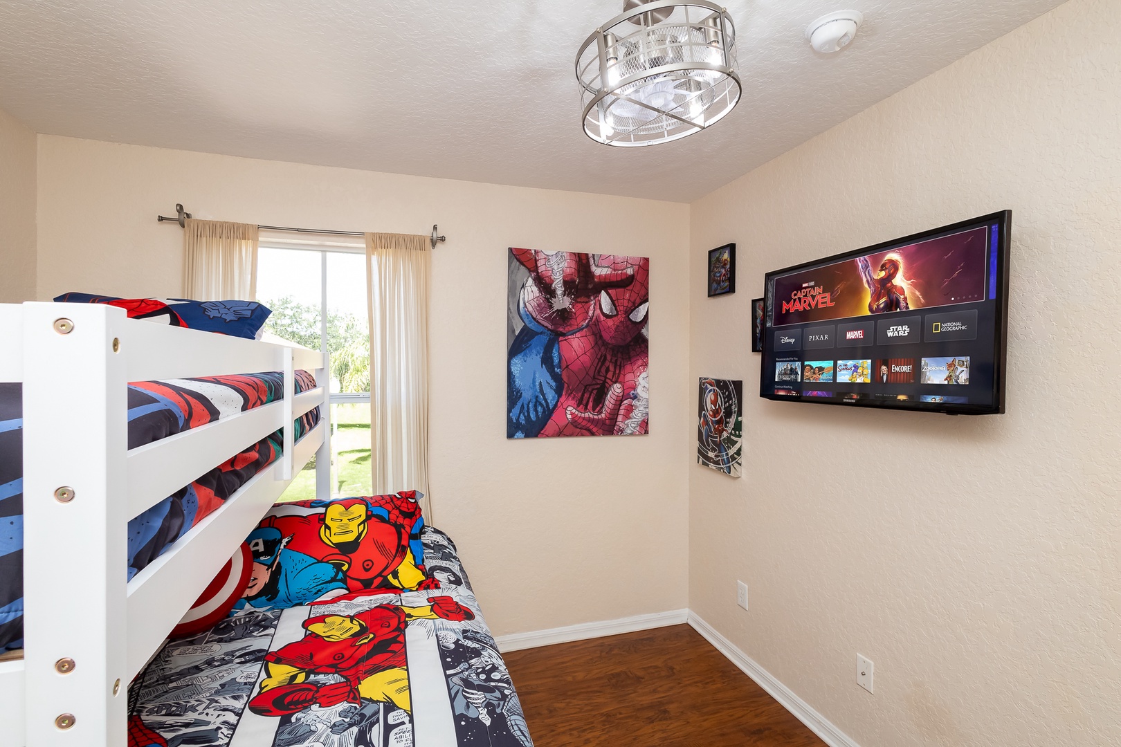 Superheroes can slumber on this bedroom’s twin/queen bunks & twin trundle