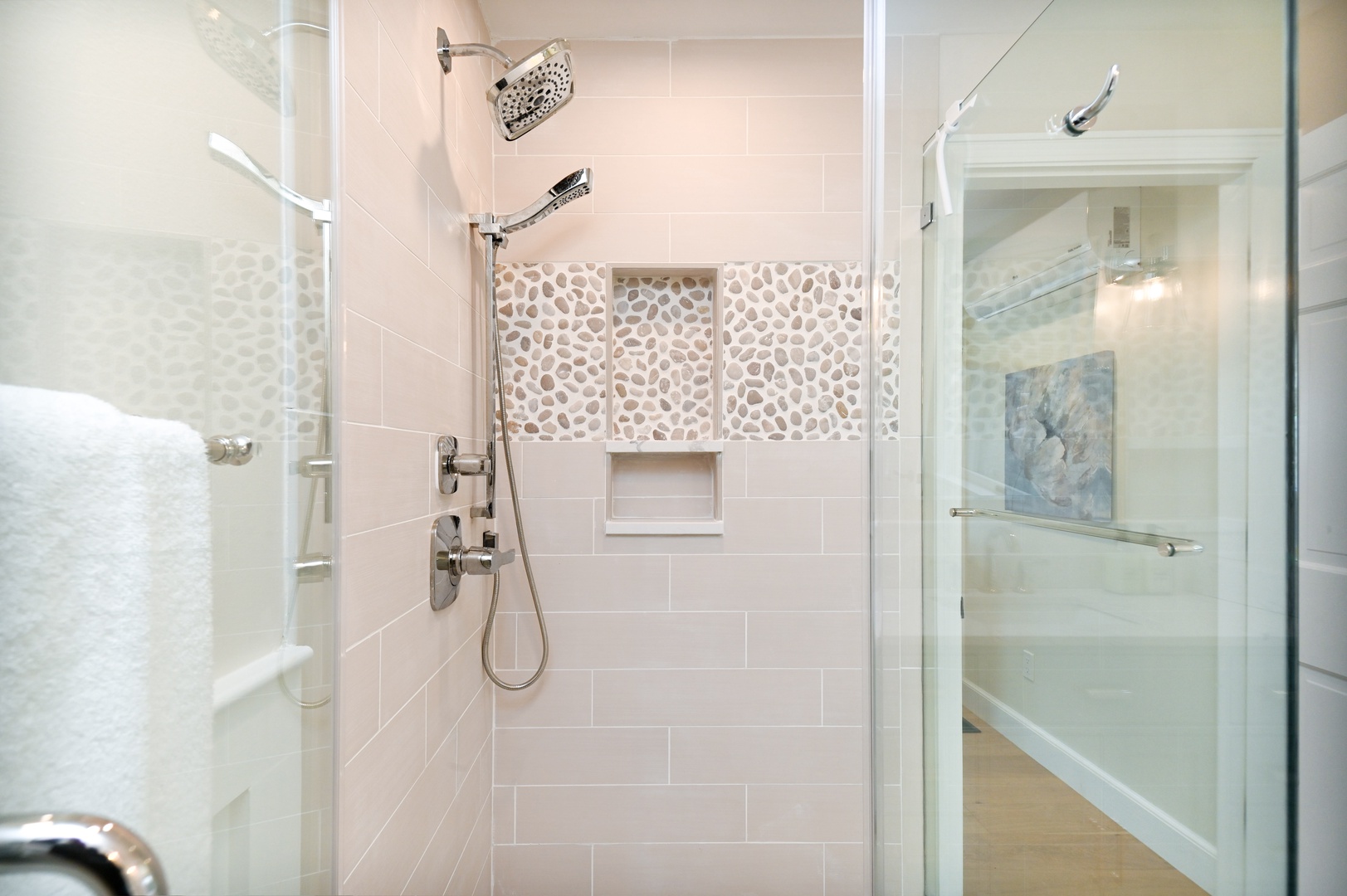 Harbor View’s chic ensuite bath includes a single vanity & luxe glass shower