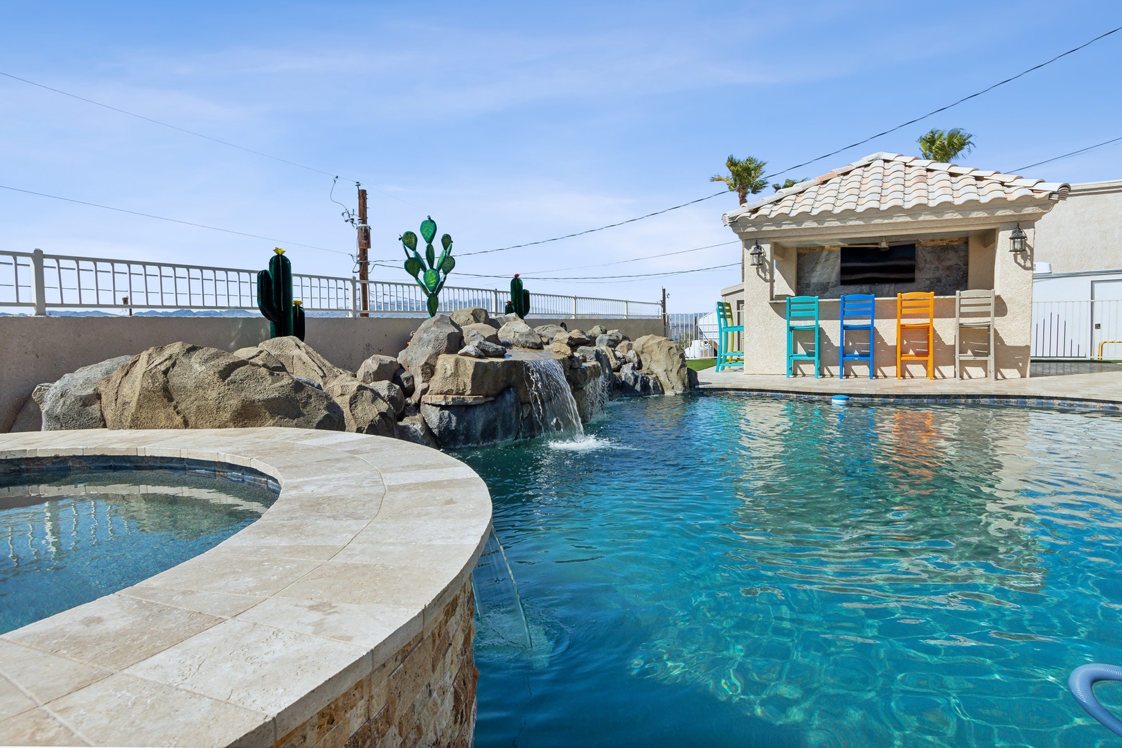 A mountain-view oasis, with a waterfall pool, hot tub, & outdoor kitchen!